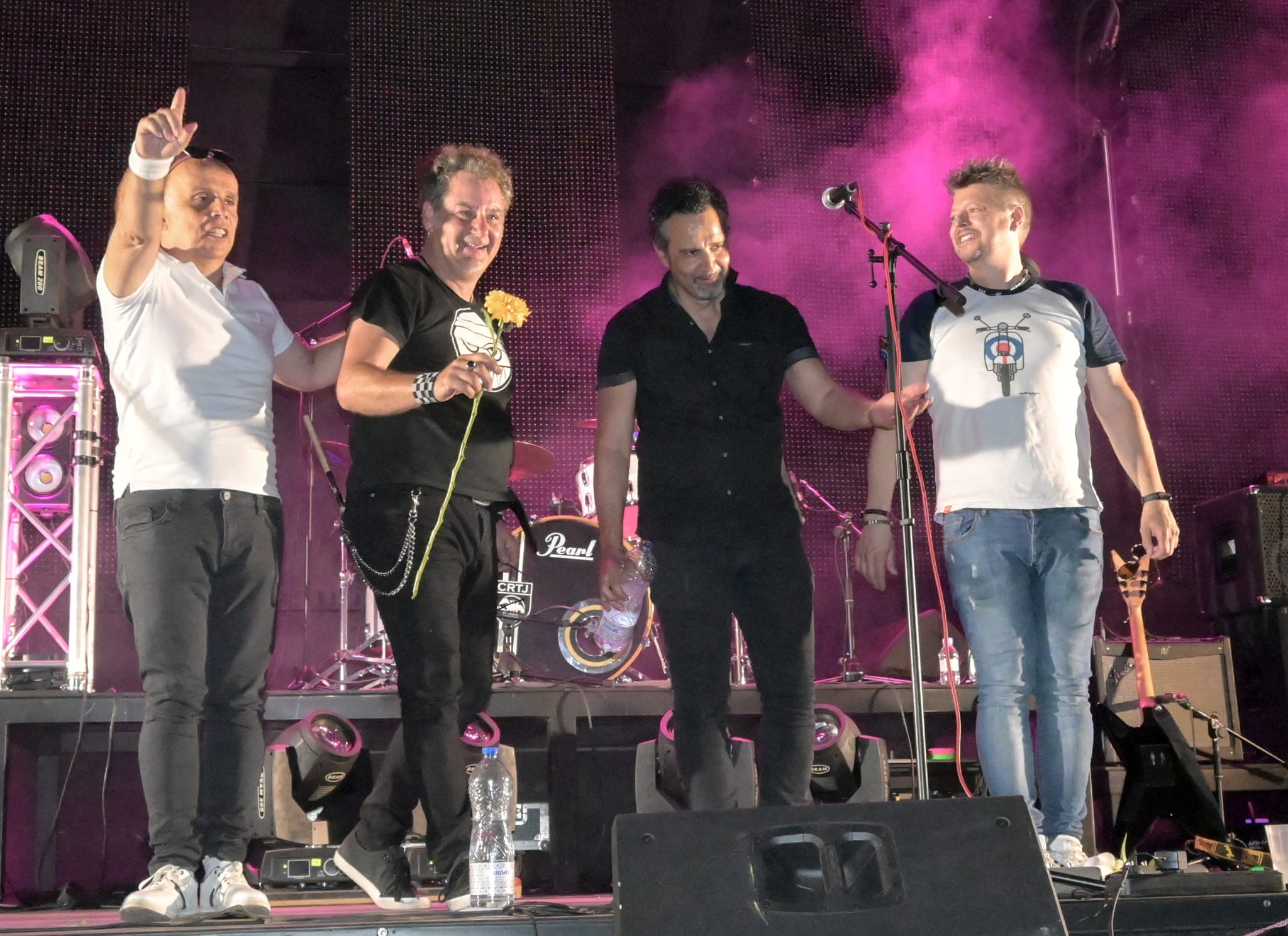 a group of men standing on a stage