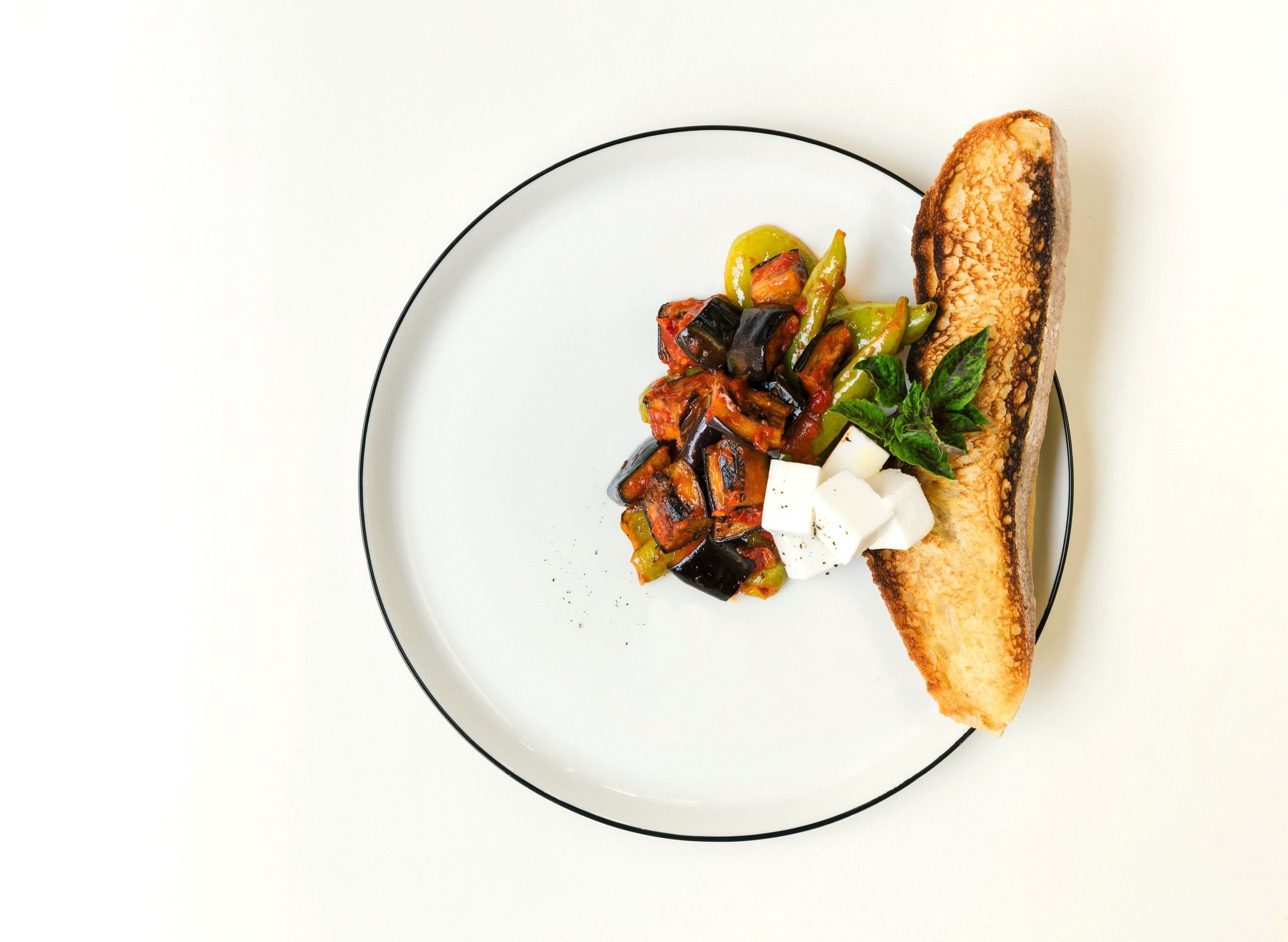 Vegetables with grated tomatoes served with feta cheese and bread- a dish by Villa Eats in Naxos 