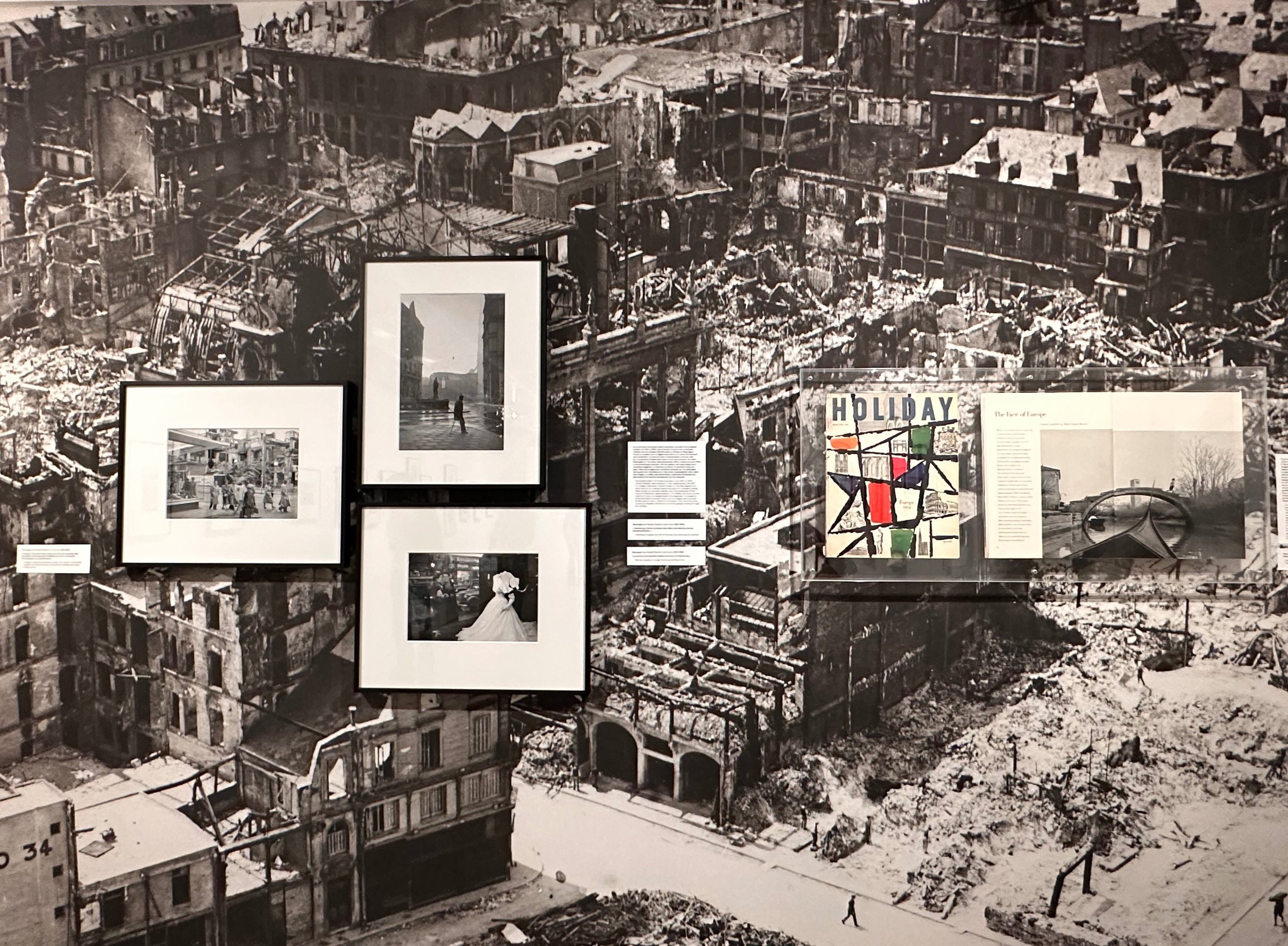 Western Germany, 1952-1953 Cologne, along a busy street, amidst ruins, modern stores have opened