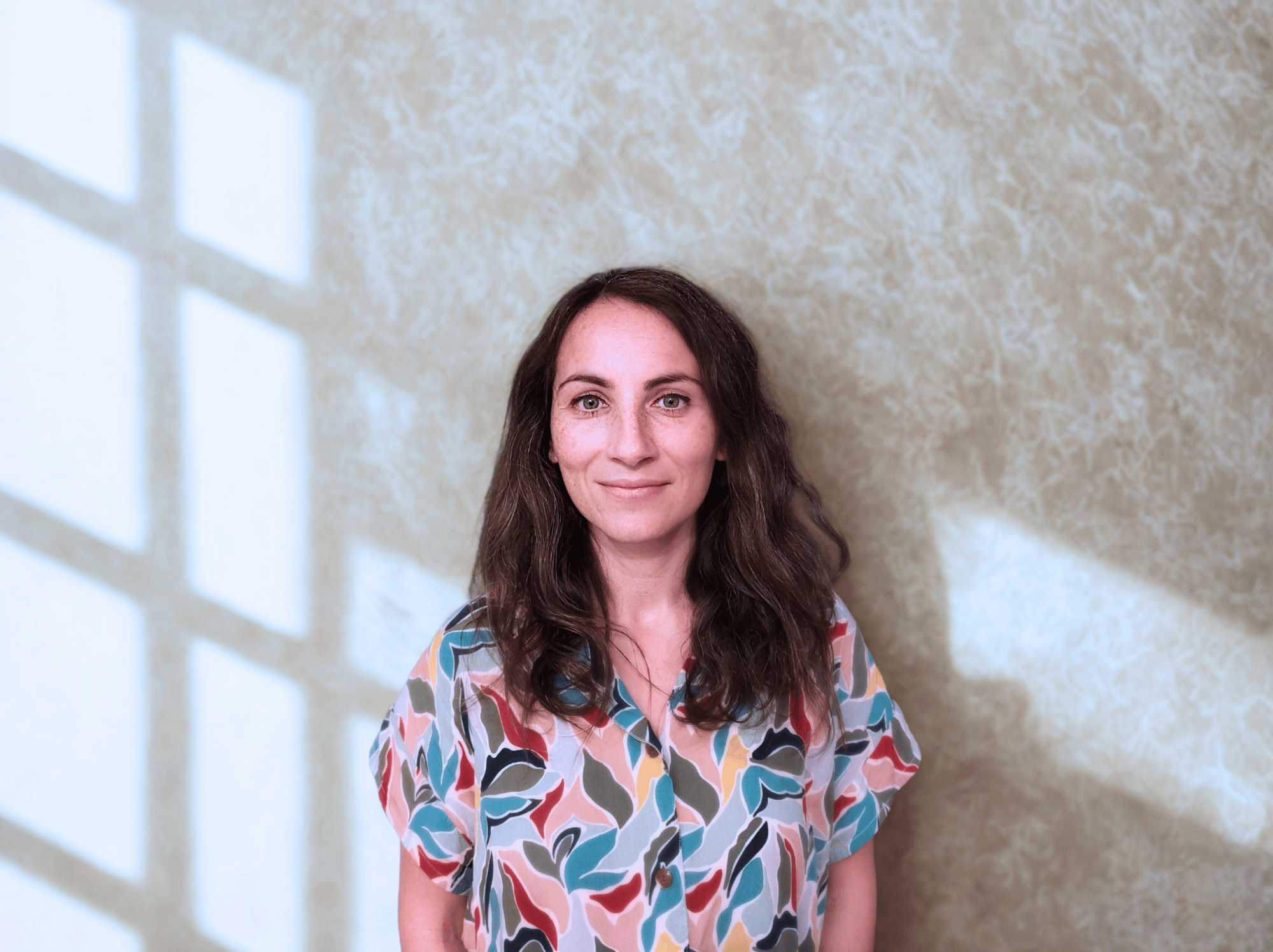 a woman in a colorful shirt and jeans
