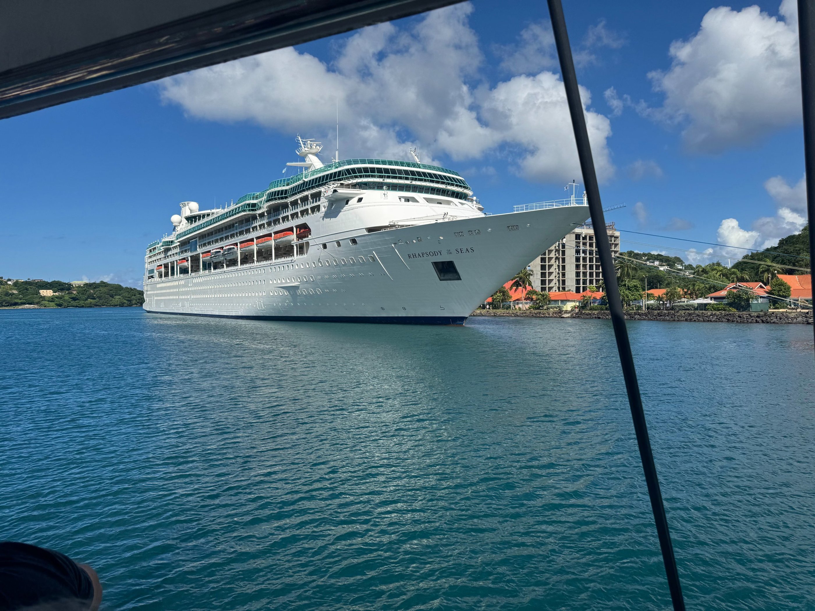 Rhapsody of the Seas cruise ship docked at port, Royal Caribbean vessel with white exterior and mult