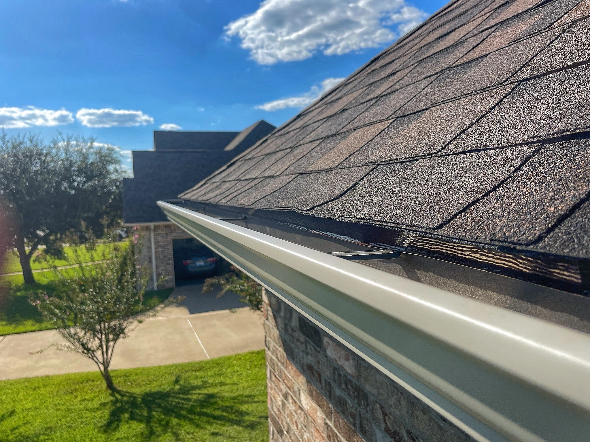 Brand new gutters installed following a full roof replacement for customer in Bullard, TX