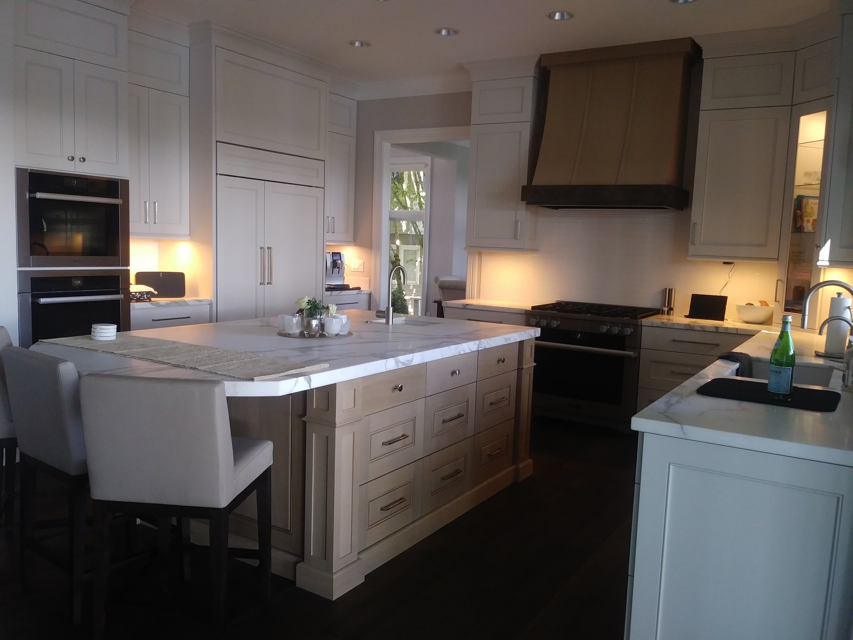solid Caesarstone island countertop with white oak cabinets