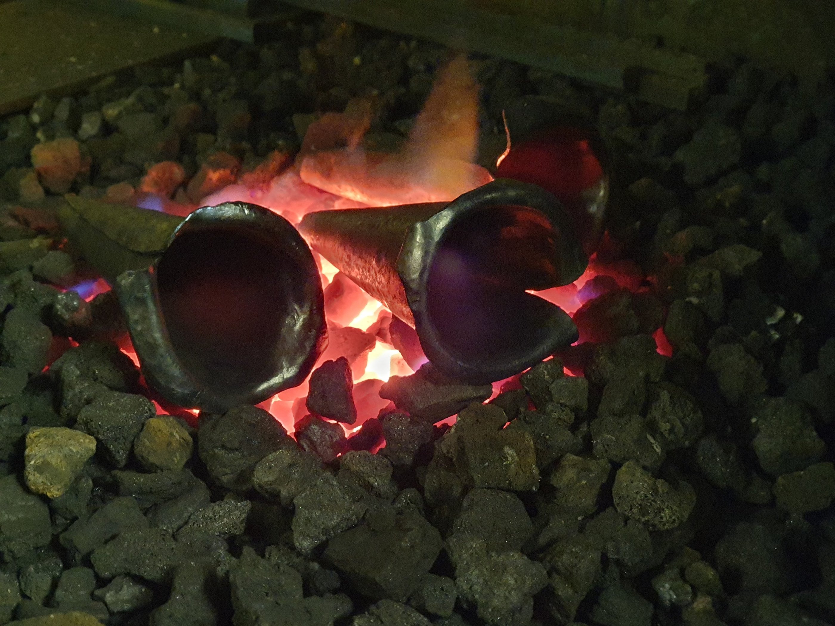 steel calla lilly in forge with glowing coals