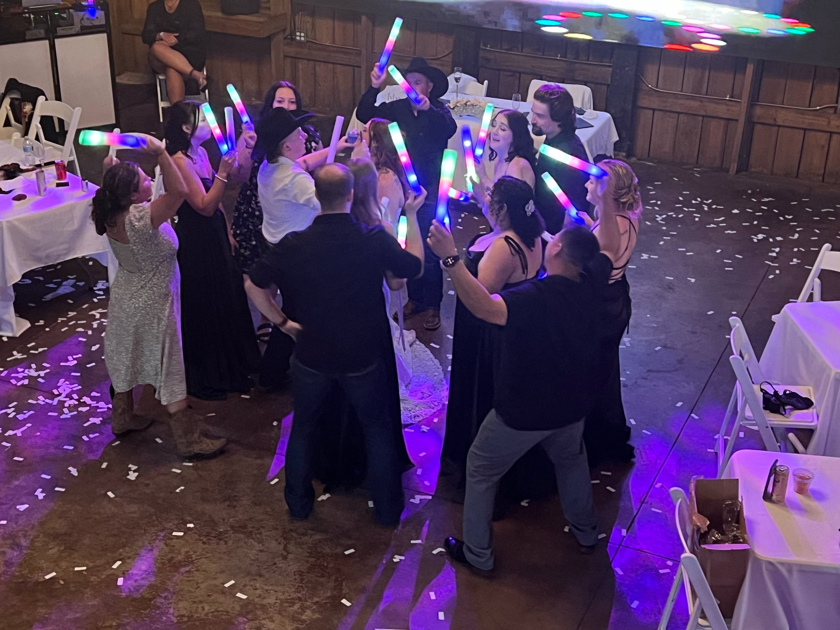people dancing with lighted foam toys
