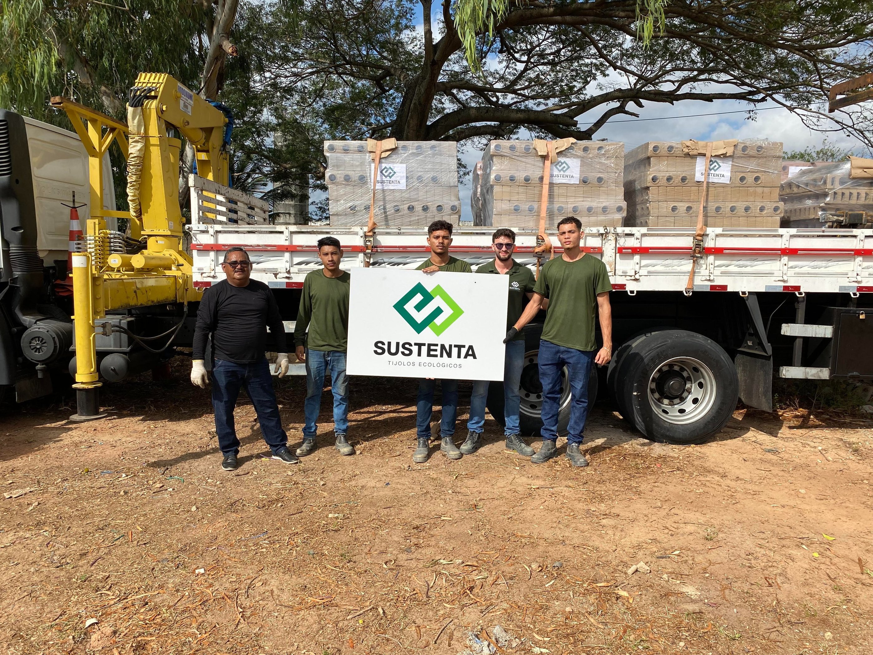 a group of men standing in front of a truck
