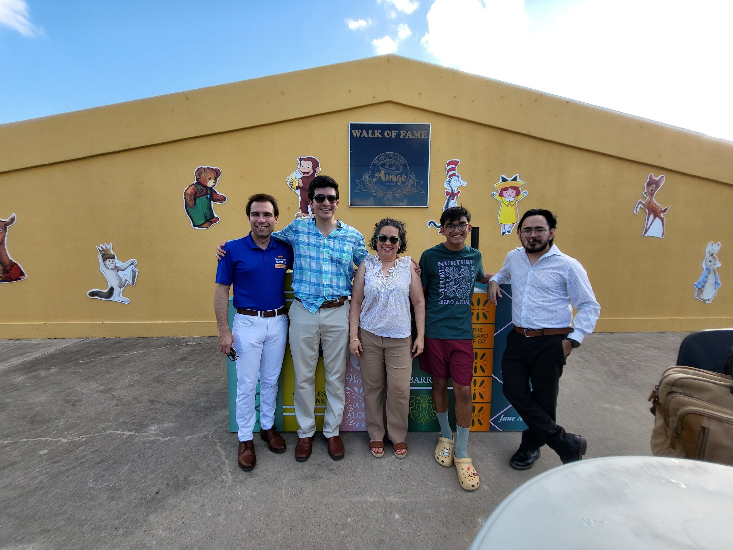 A group of people taking a picture side by side