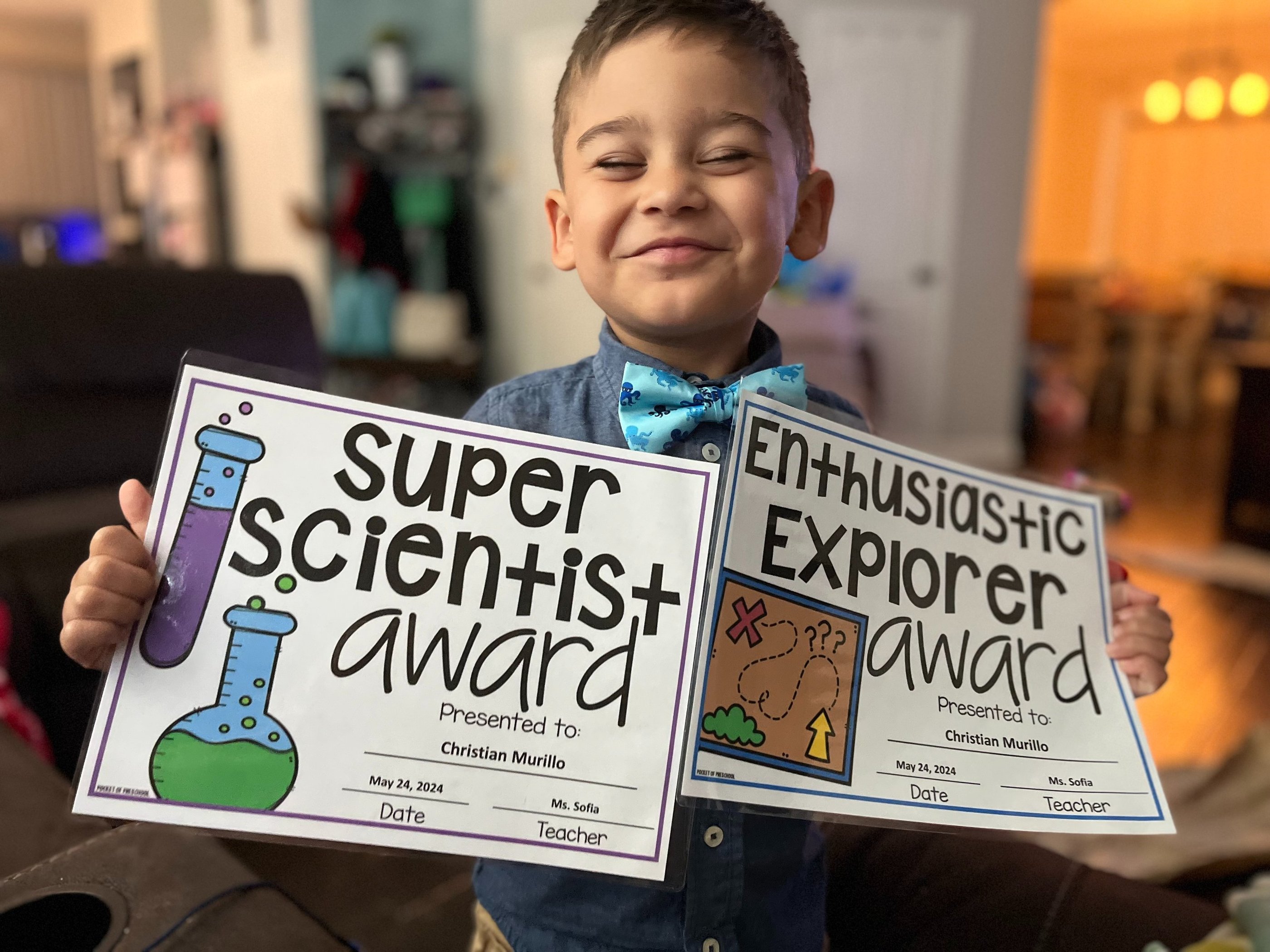 boy holding certificates