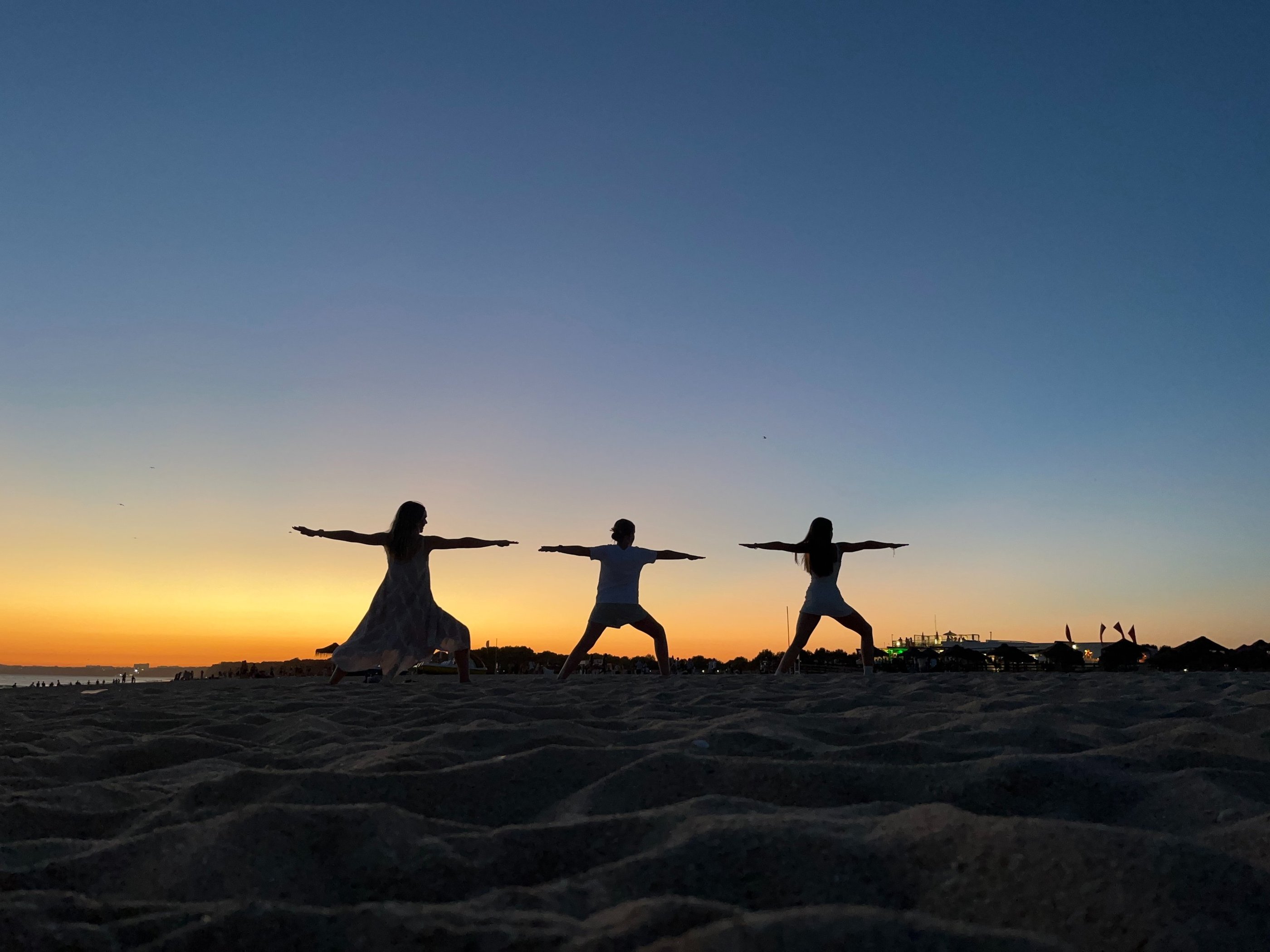 Katie Prickett Warrior 2 pose with daughters on beach