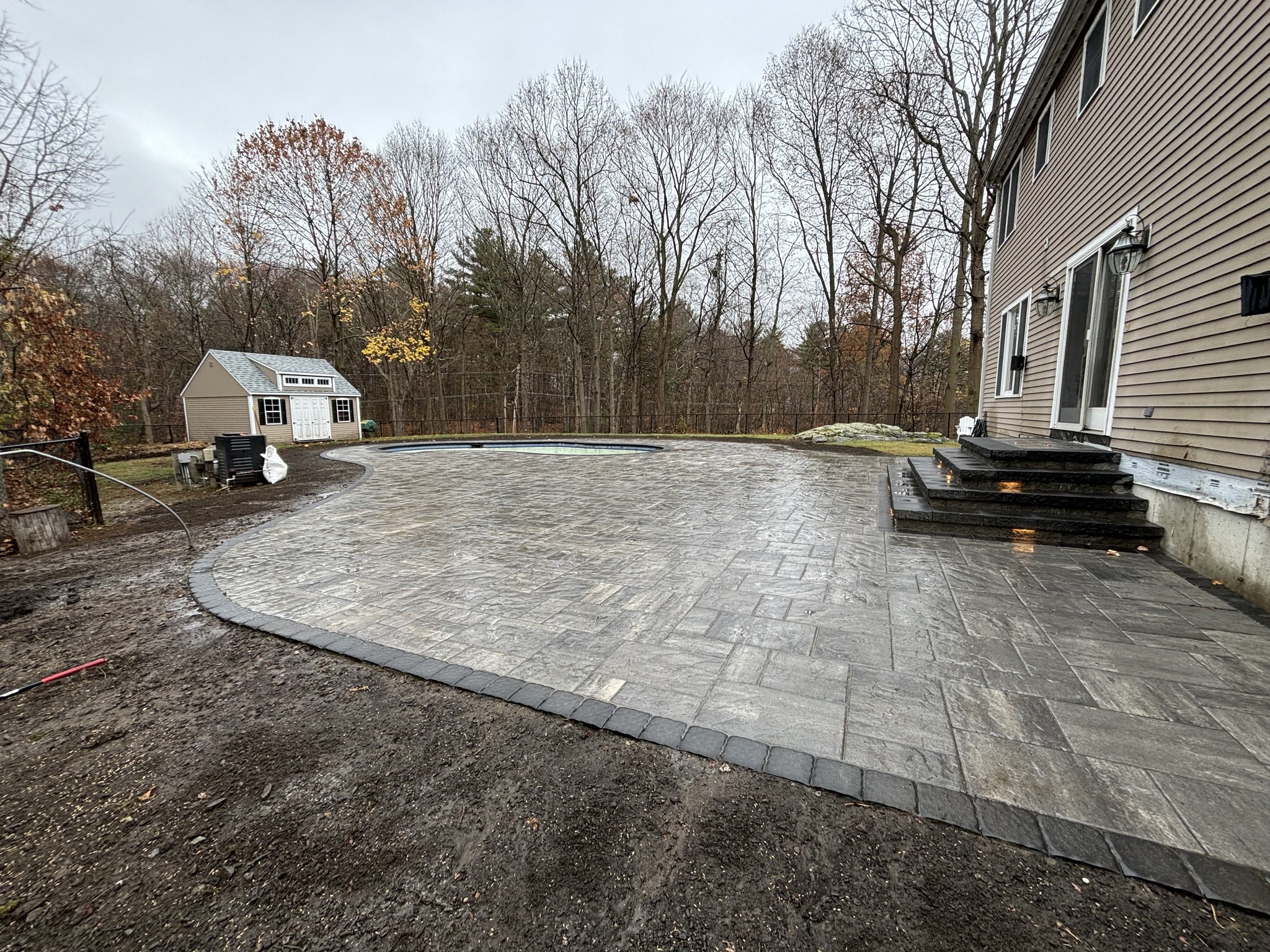 outdoor patio surrounding pool area in North Shore MA