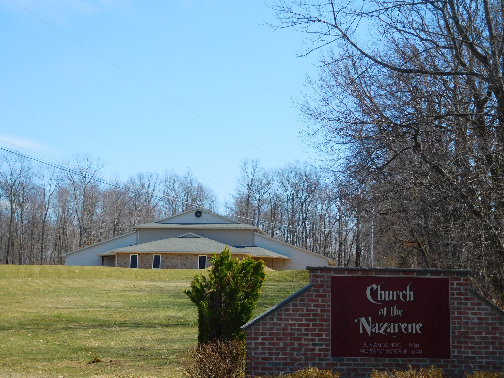 a church sign with a church in the background