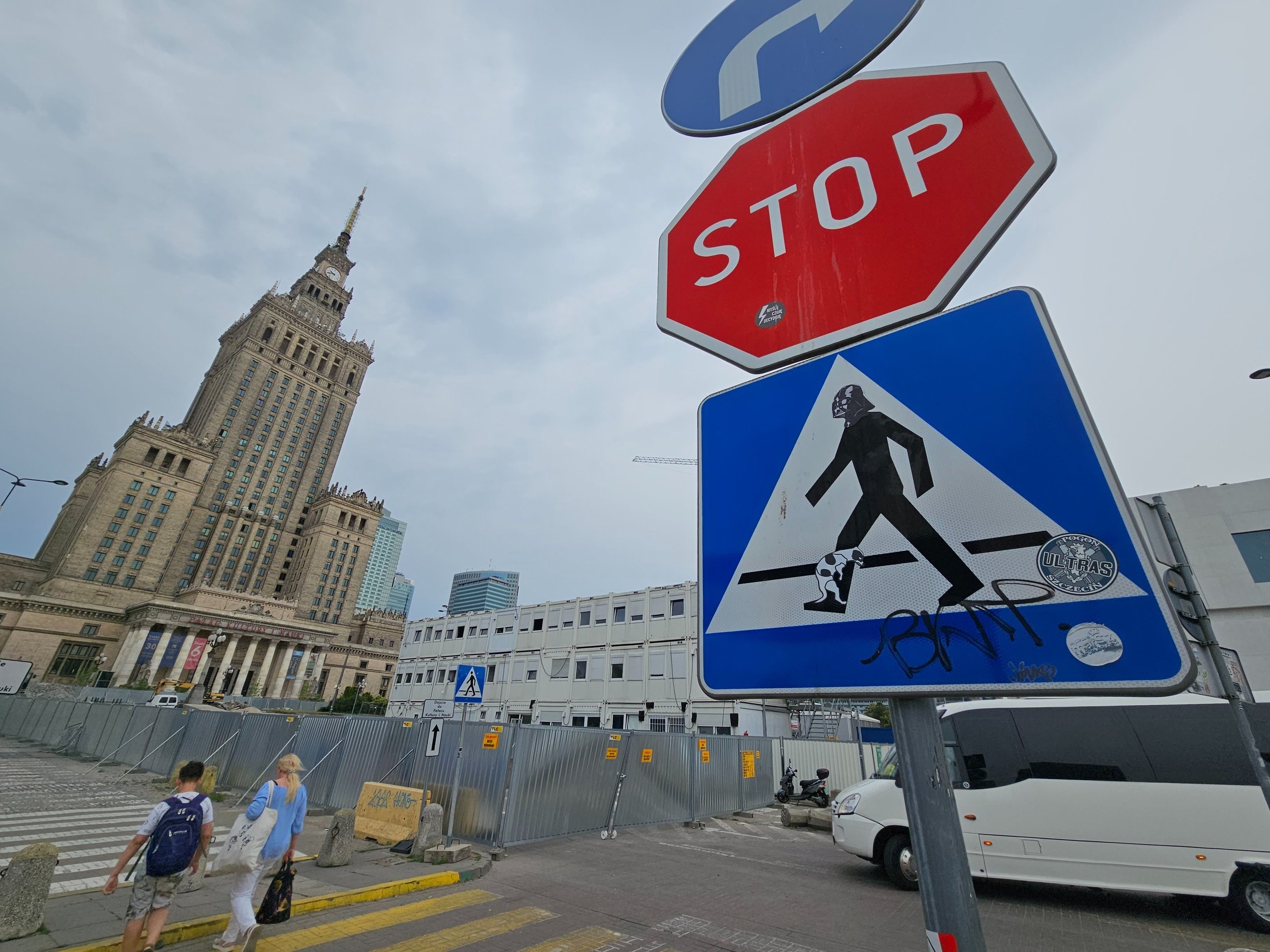 a stop sign with a pedestrian crossing sign