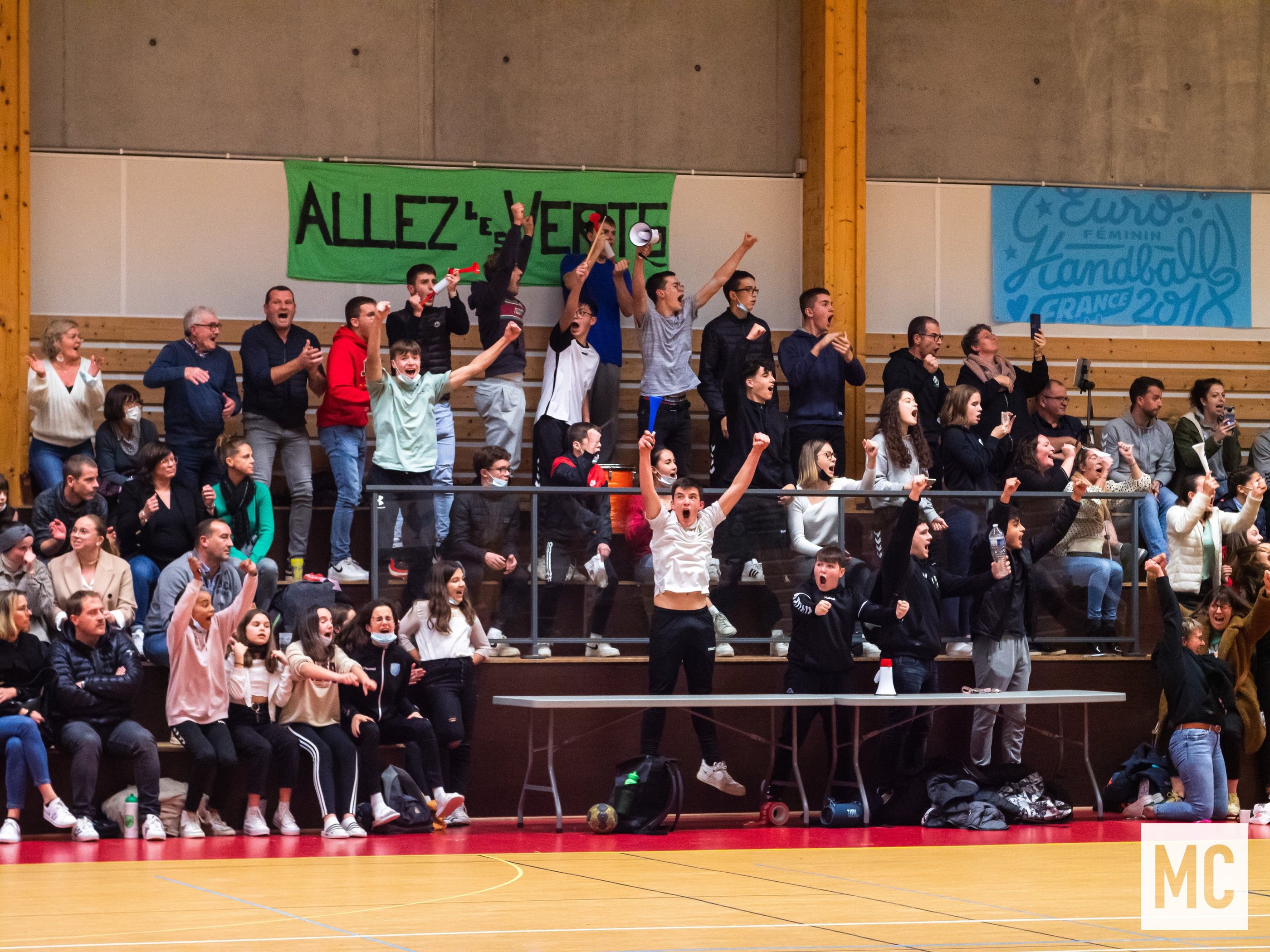 a group of people standing in front of a crowd of people