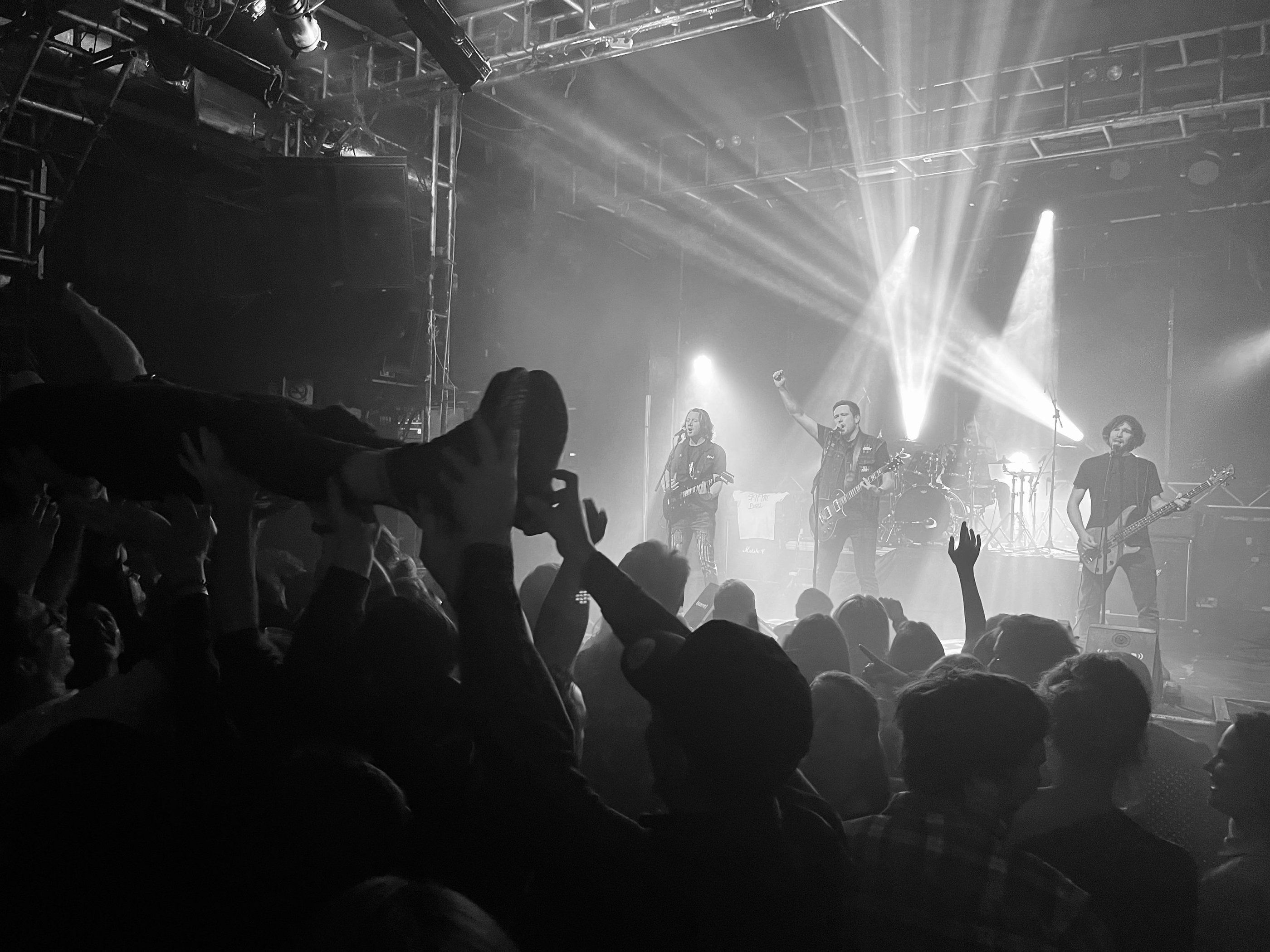 a band playing a concert in a dark room