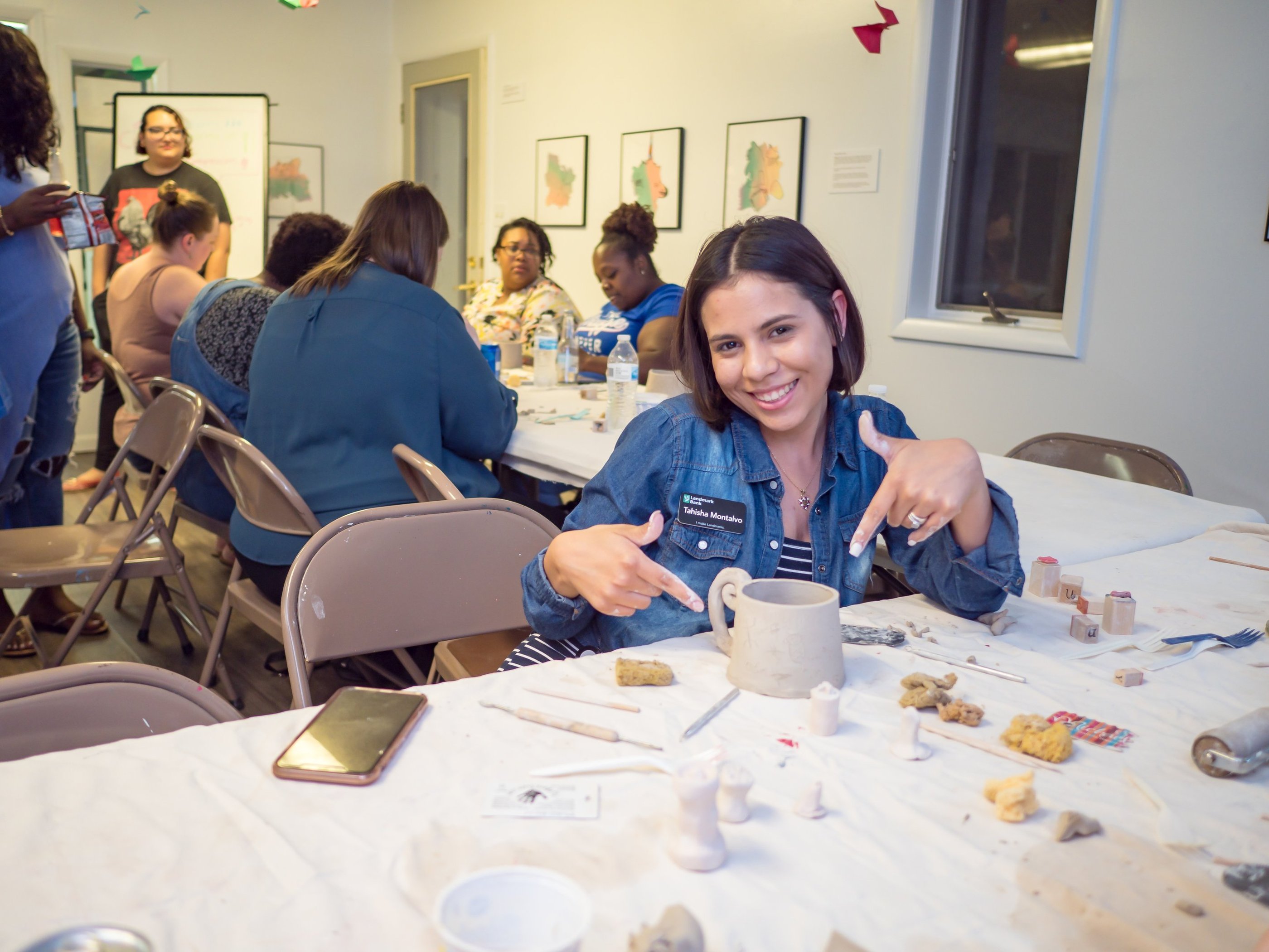 An individual posing with the slab mug she built.