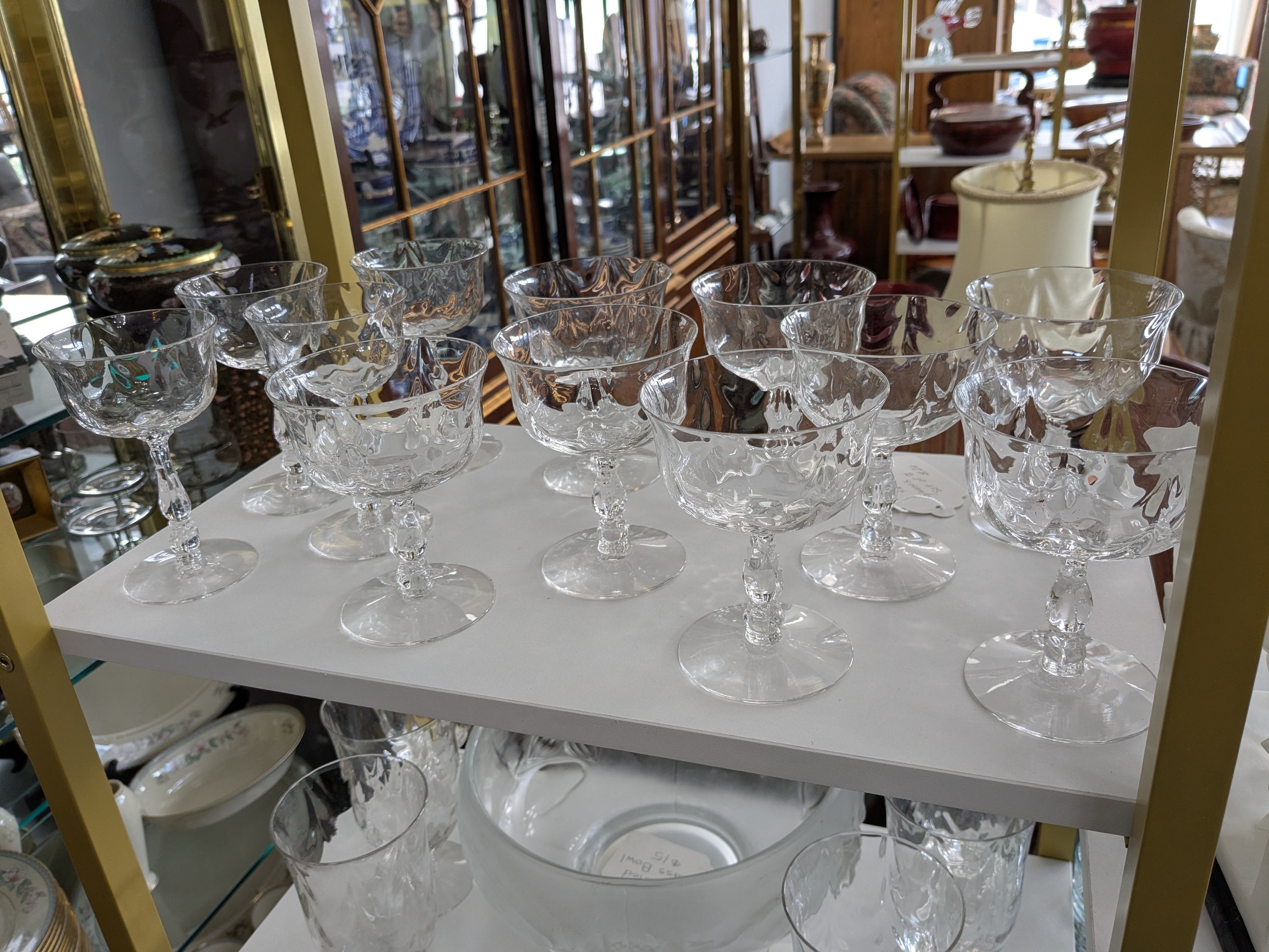 a shelf with wine glasses