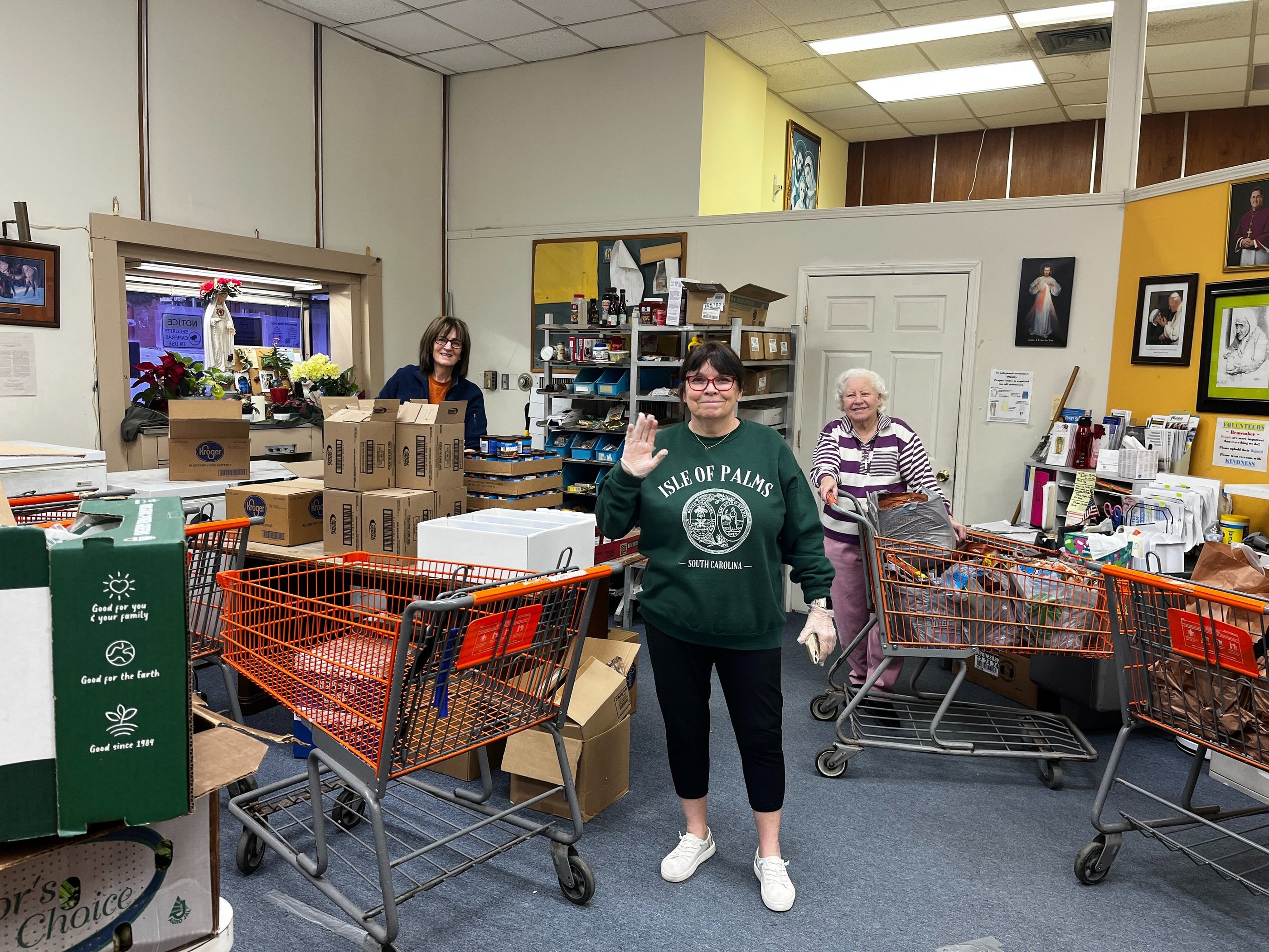 A group of happy volunteers working in the food pantry