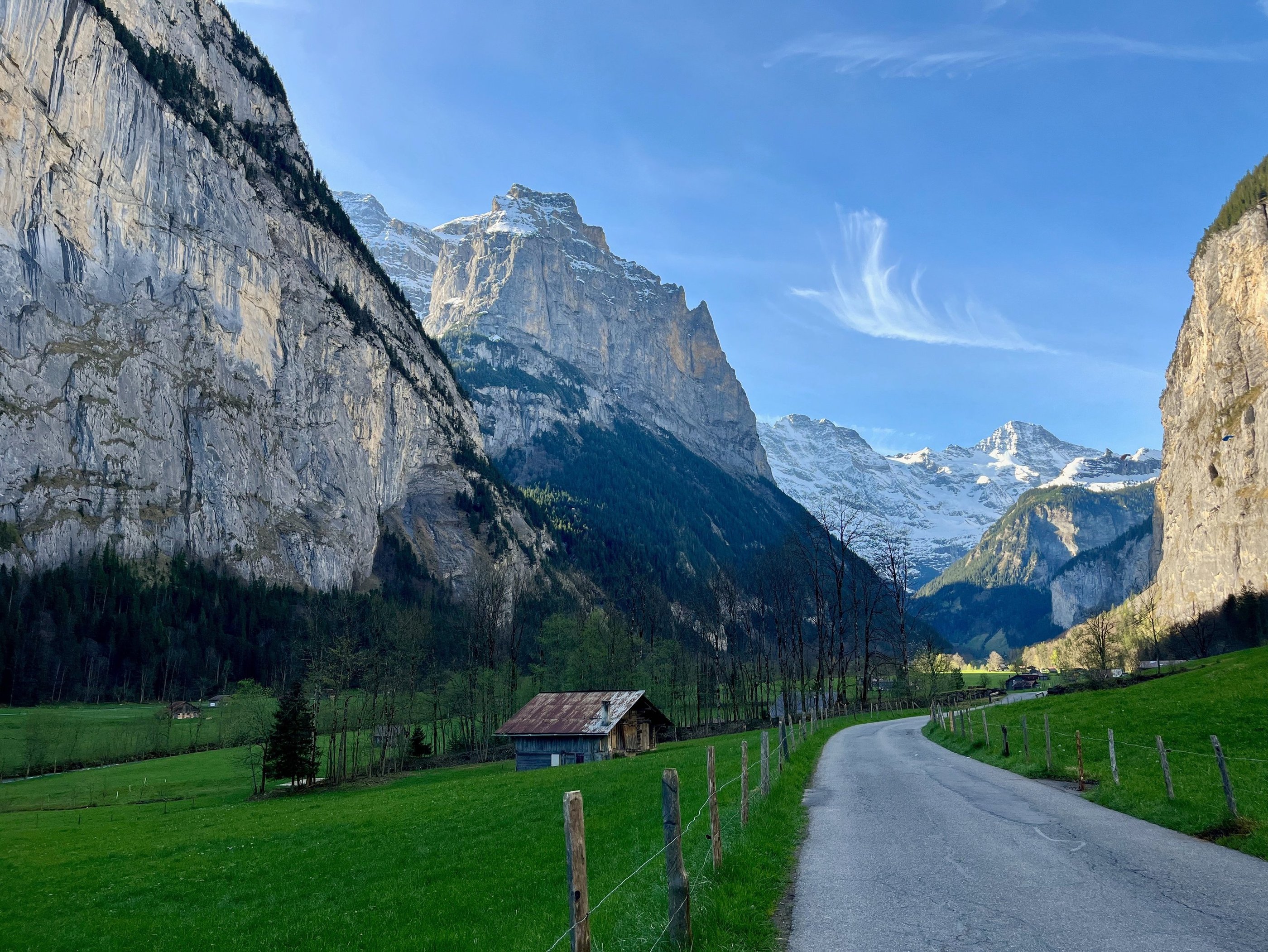 View looking up the Lauterbrunnen Valley in Switzerland with limestone cliffs towering above
