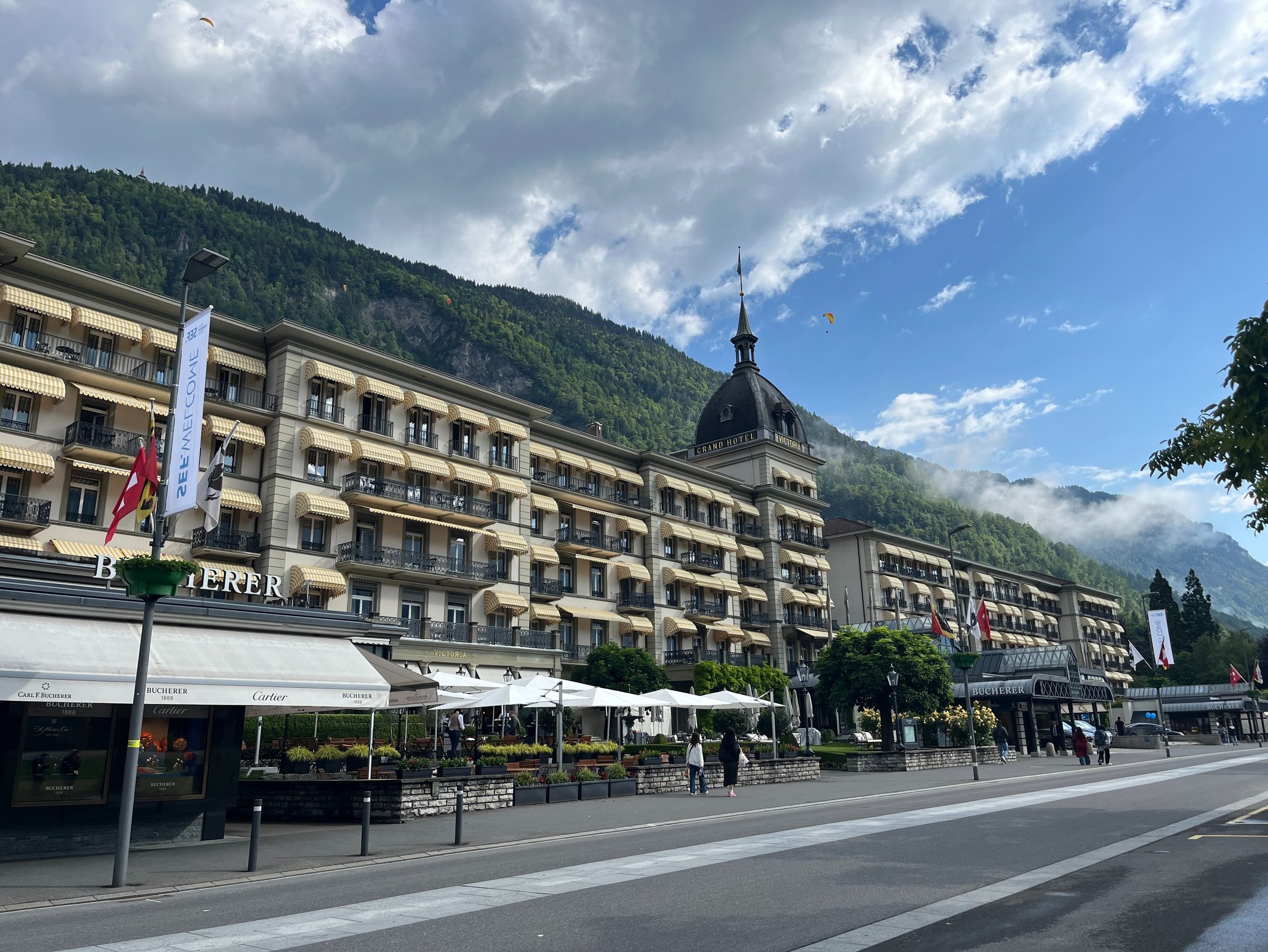Victoria Jungfrau Hotel in Interlaken Switzerland with paragliders over head