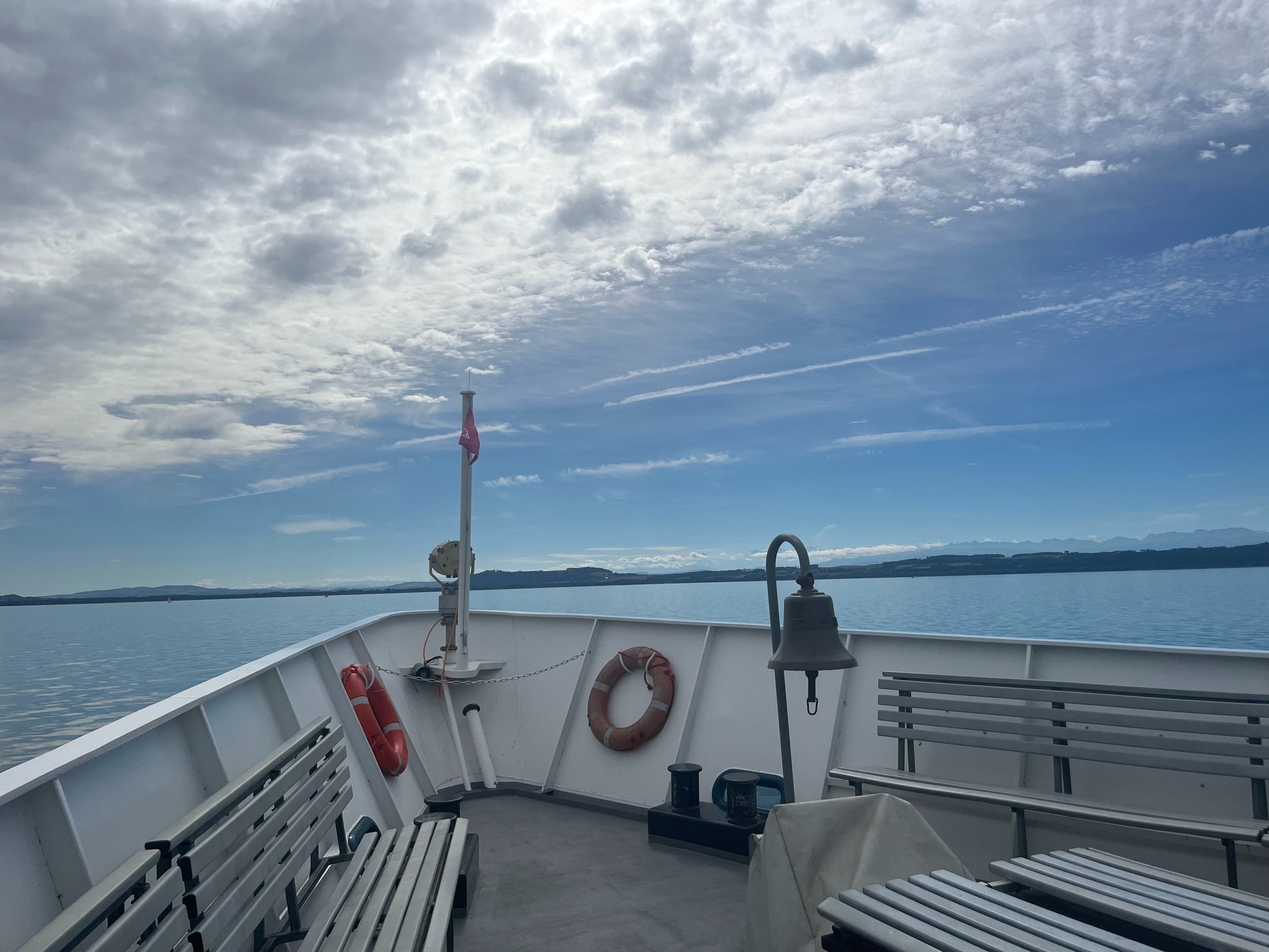 The Swiss and French Alps far off in the distance from a boat on Lake Neuchâtel