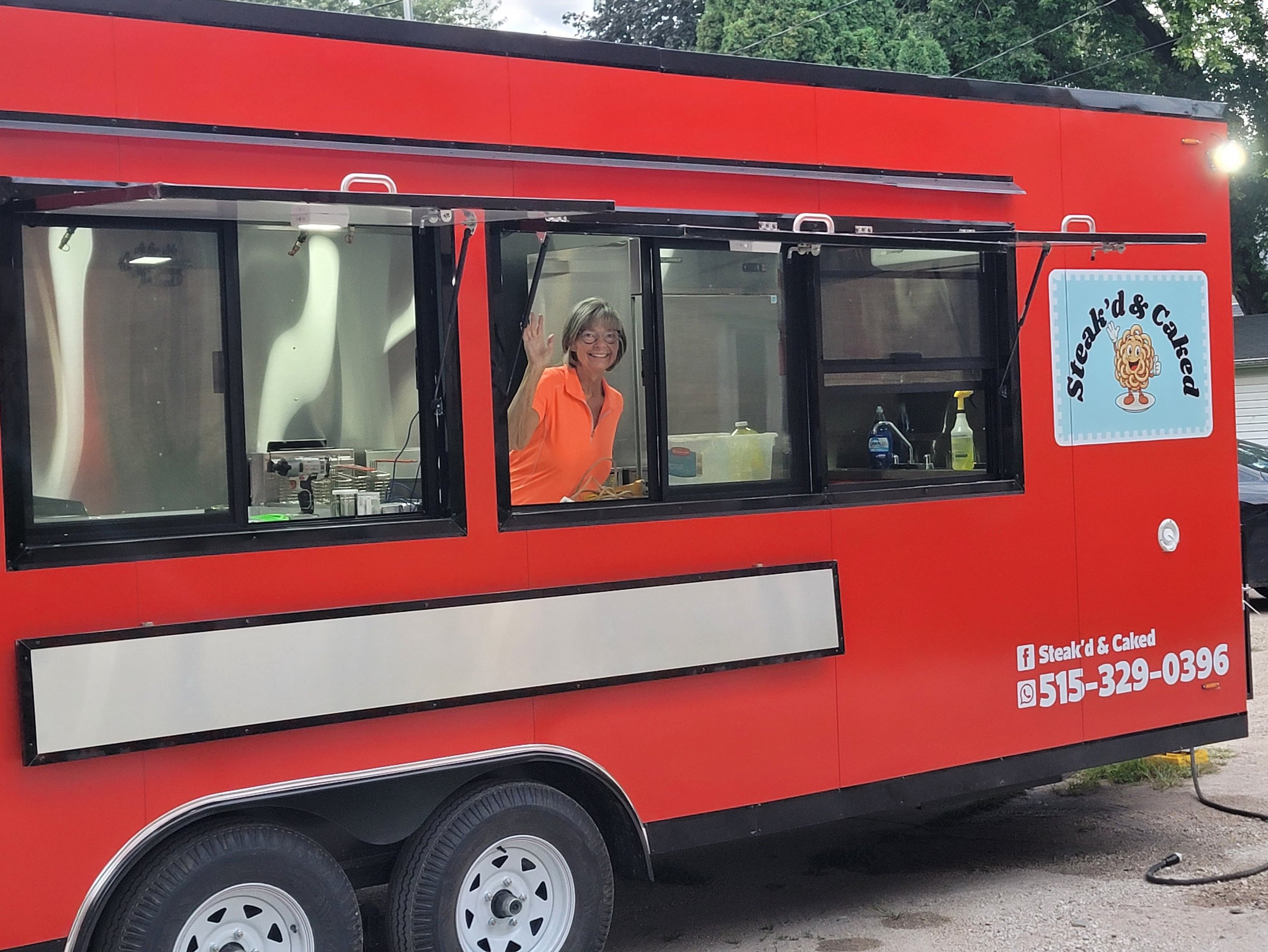 Cindy Niemier at serving window inside food trailer