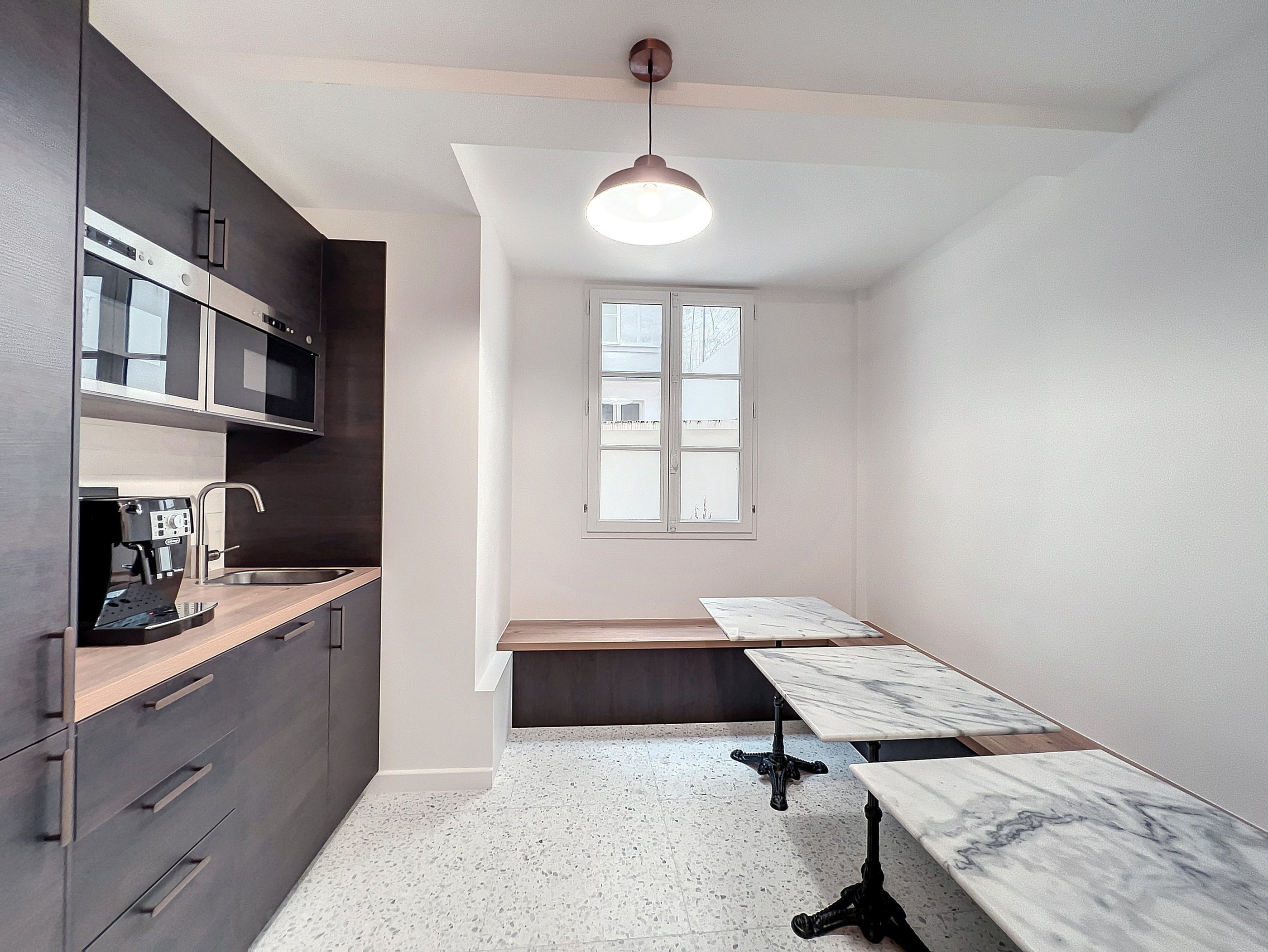 a kitchen with a marbled counter top and a bench with a bench top