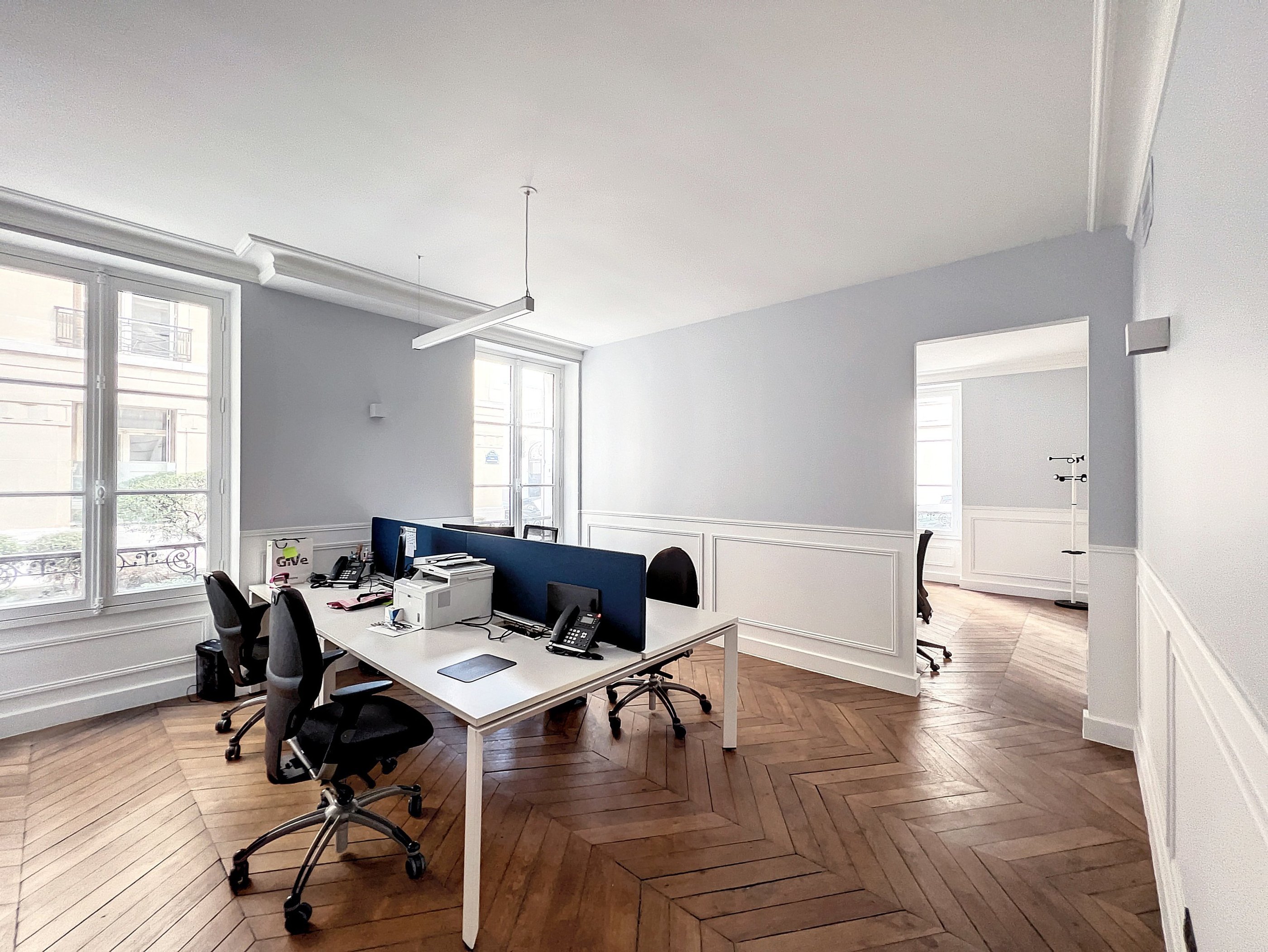 a desk with a computer and a laptop