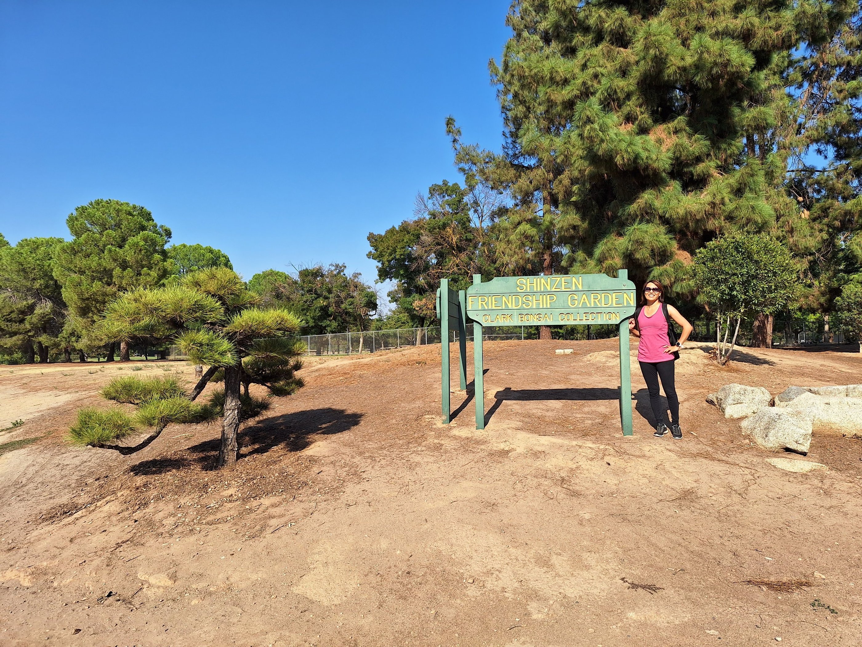Janet with the Shinzen Friendship Garden Sign