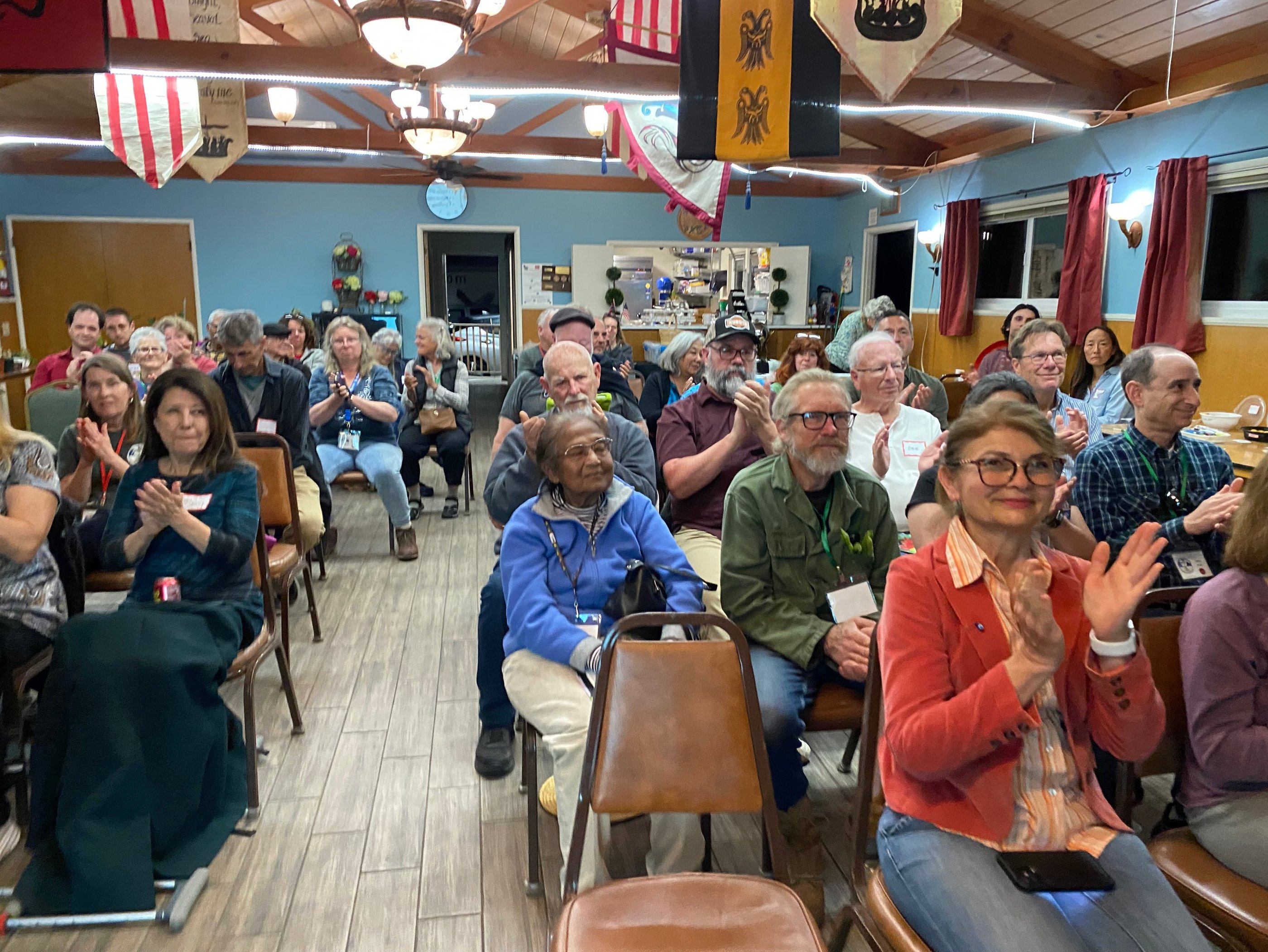 Audience applauding after a talk at a chapter meeting