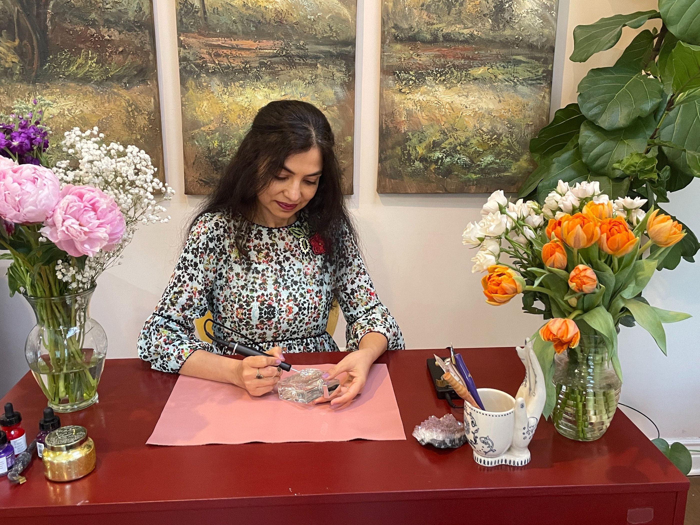 Radhika, artist behind Bella Calligraphy engraving a perfume bottle