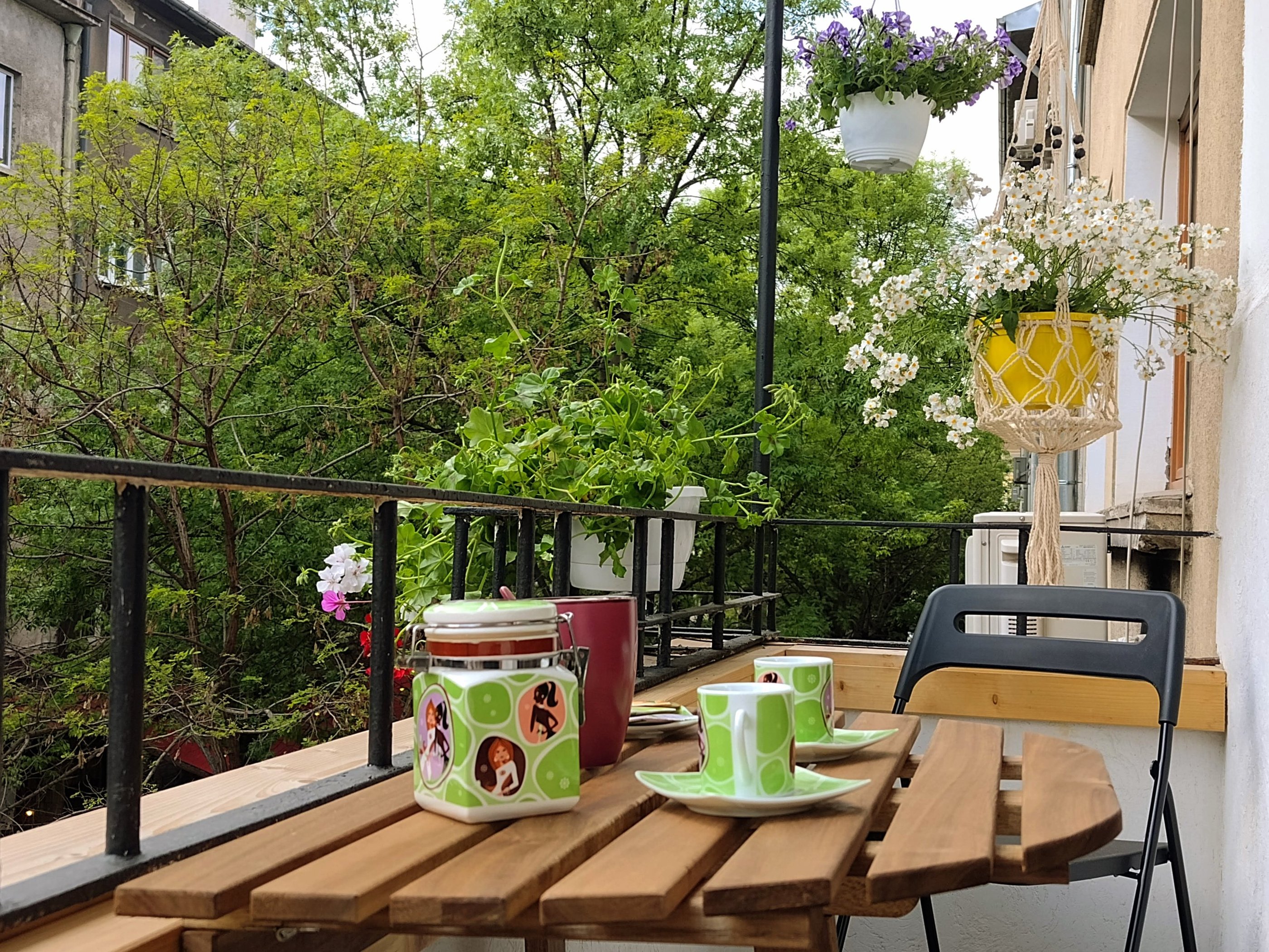 alt="Bijoux Apartment balcony with flowers and city view"