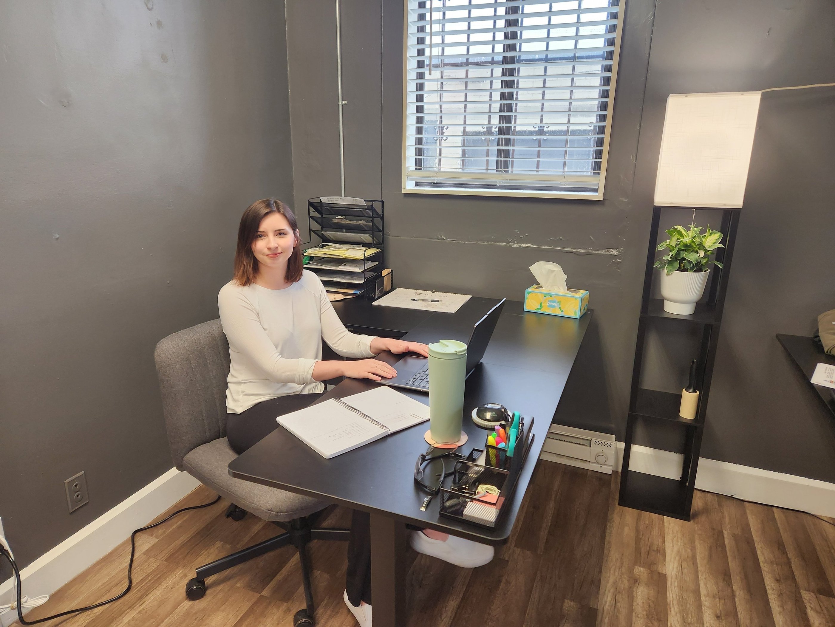 woman sitting at office desk smiling