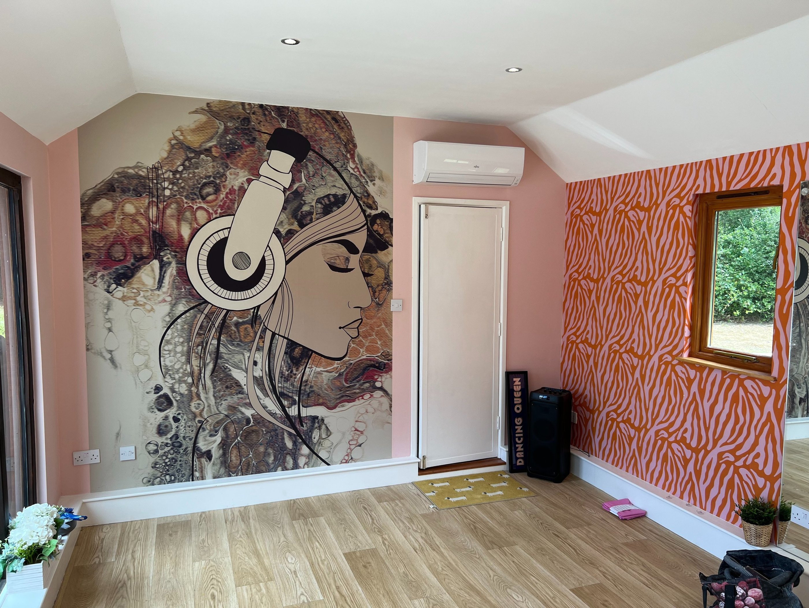 Feature wall wallpaper installation with bespoke mural and wood flooring in a Brighton home