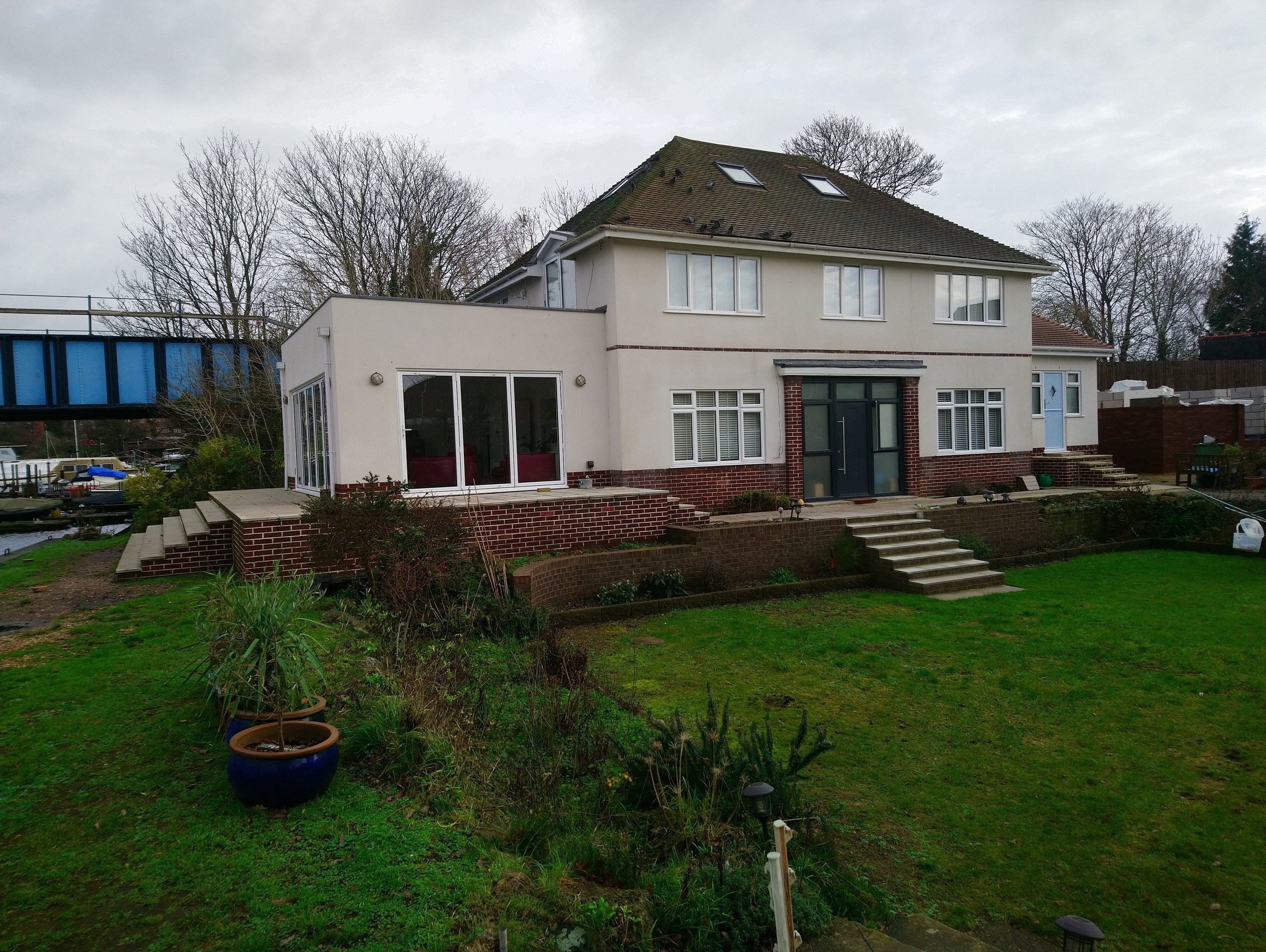 Orangery and single storey extension. With terrace overlooking a river.