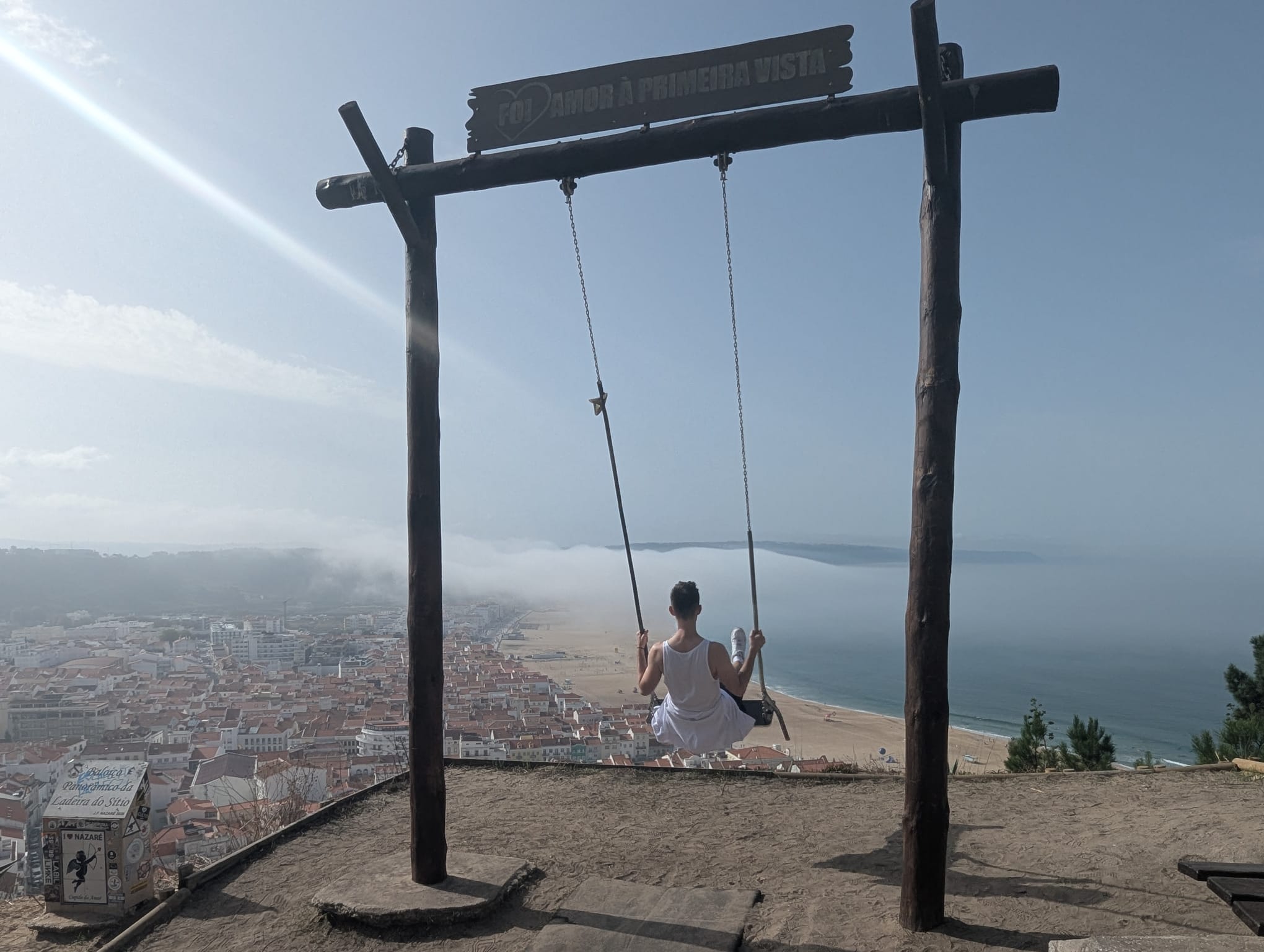 a man sitting on a swing set in a swing