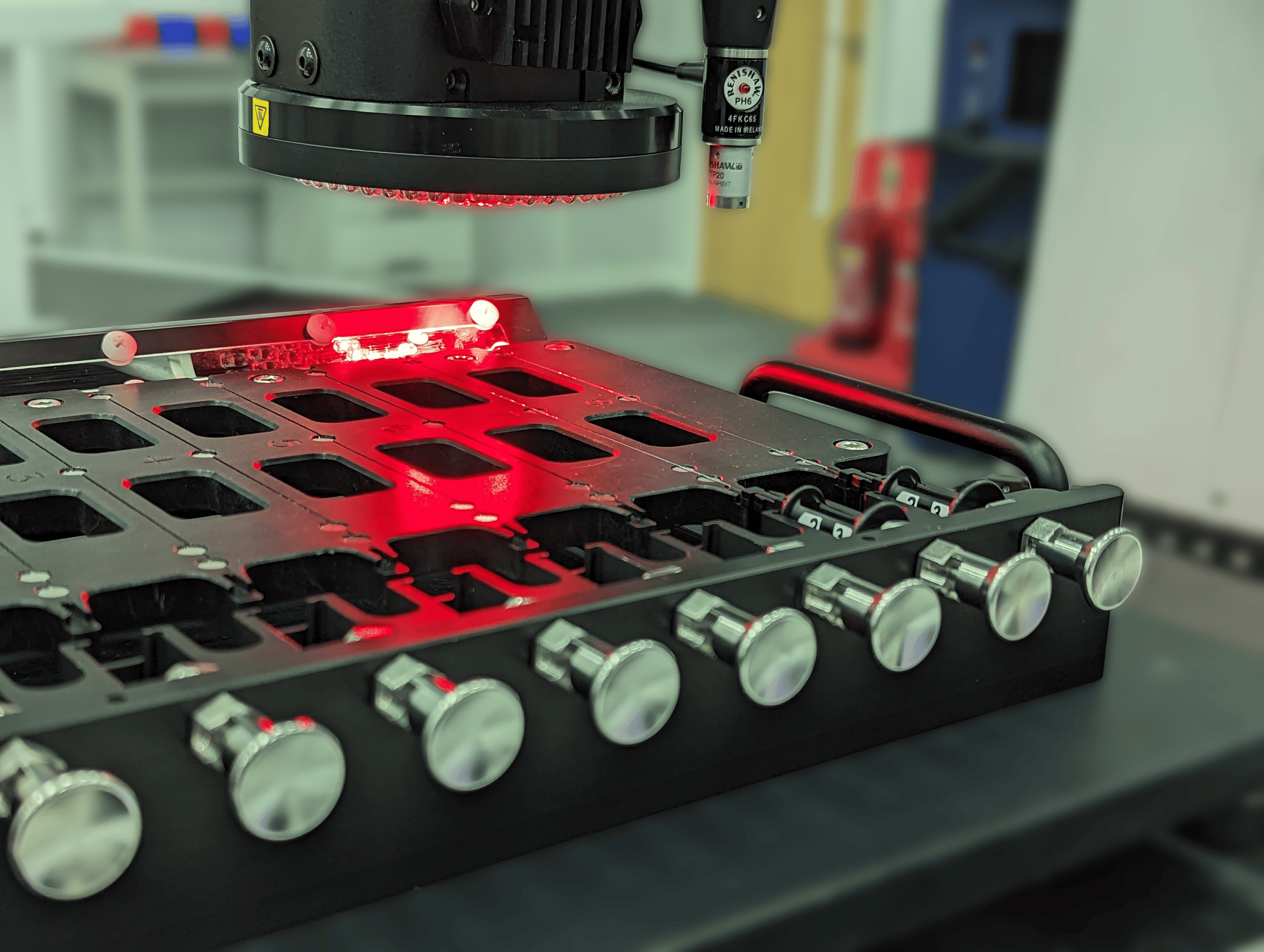 Multi-nest metrology fixture holding small thin medical devices whilst being inspected by an optical CMM.