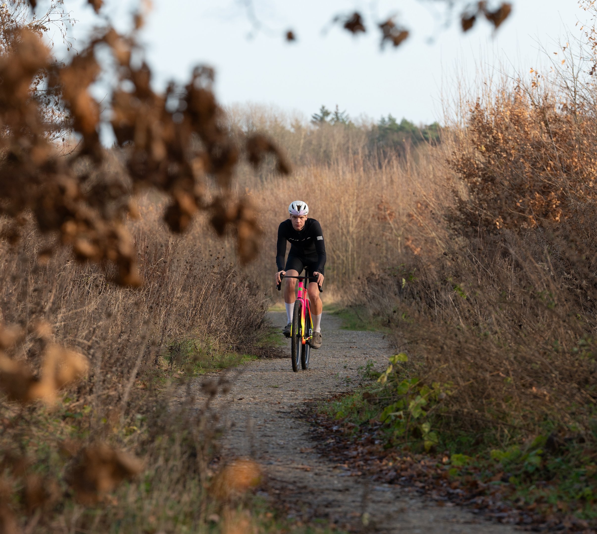a man riding a bike down a path
