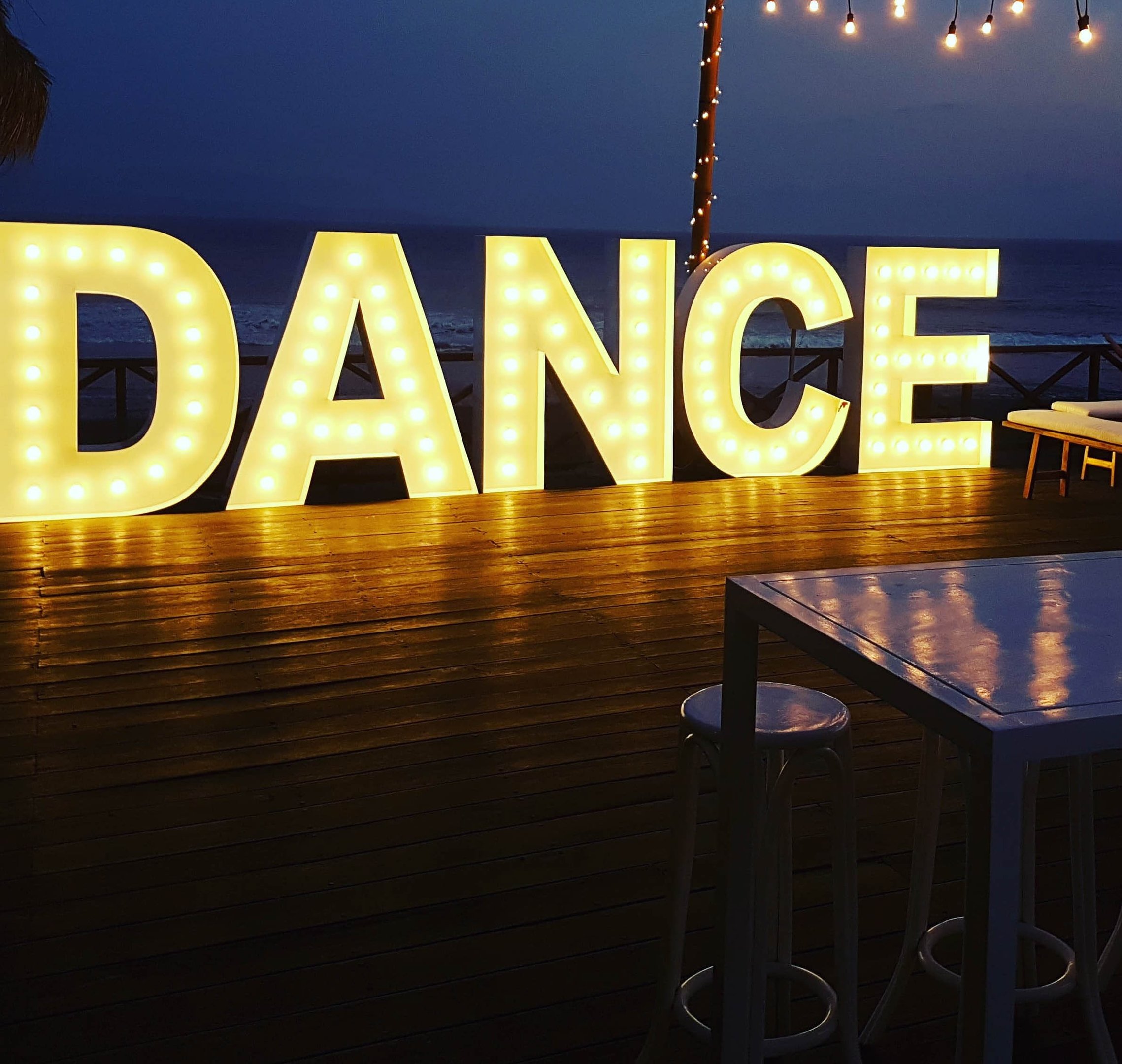 a large light up sign that says dance