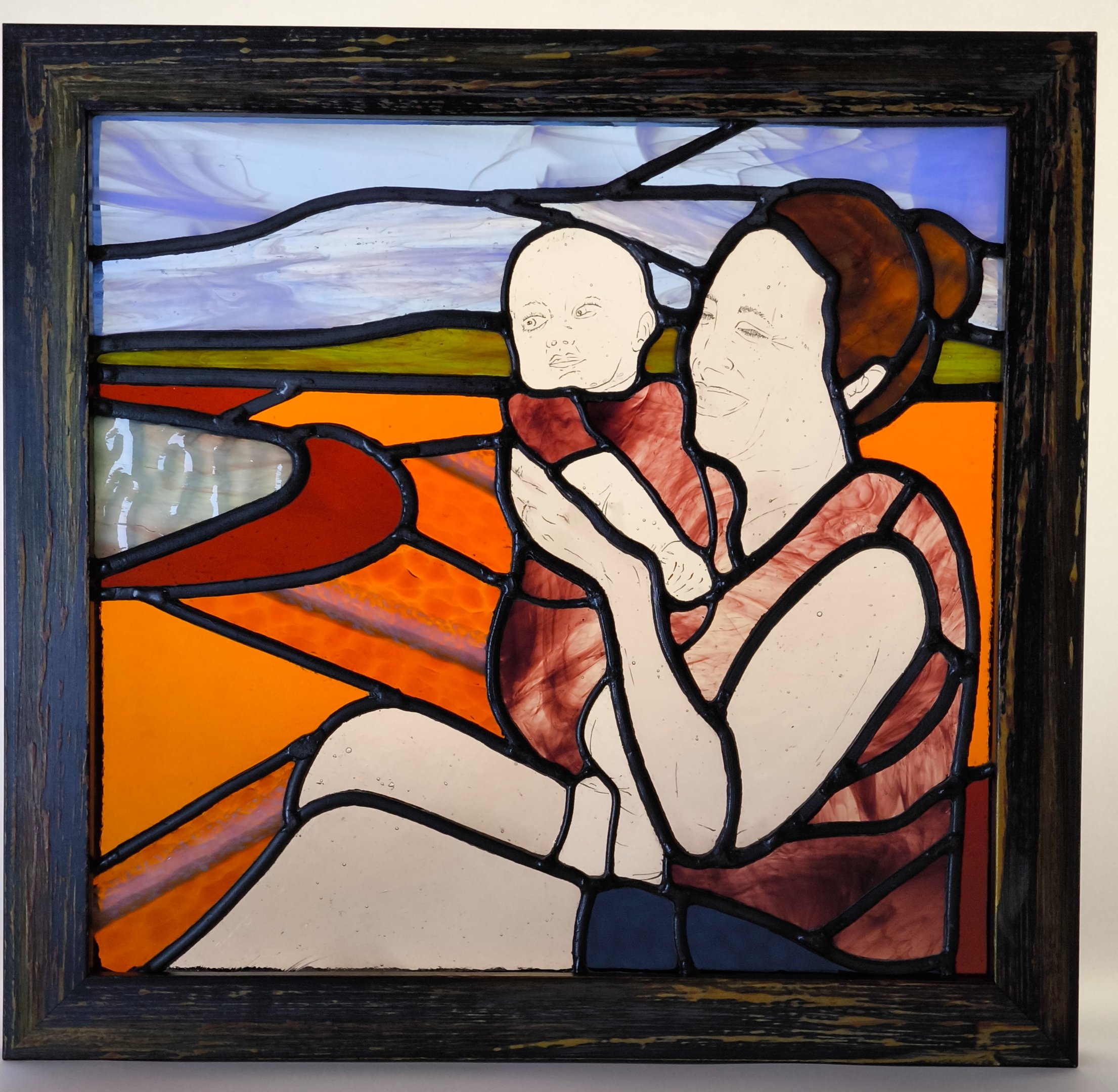 a painting of a woman holding a baby in a stained glass window