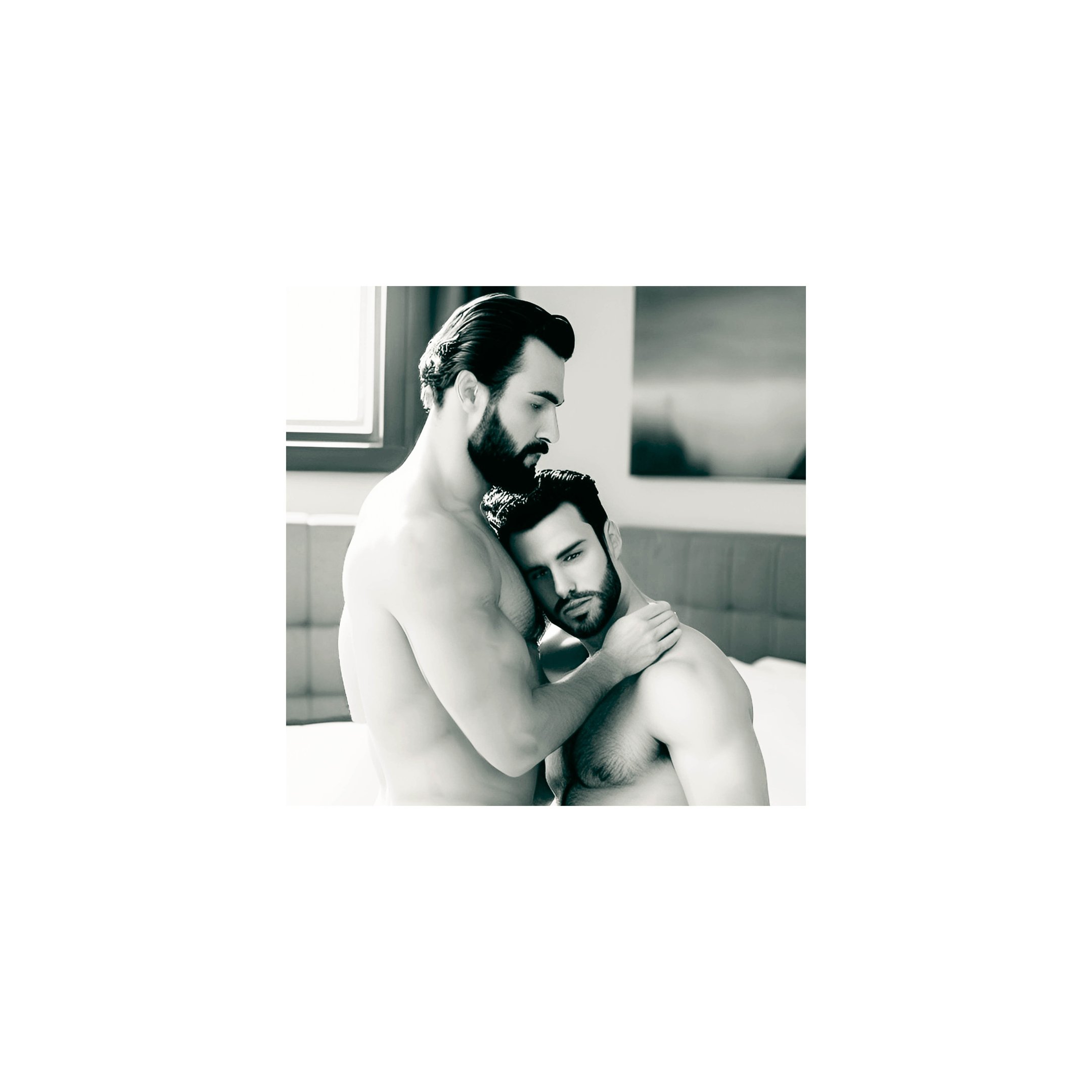 a man and man embracing in a bedroom