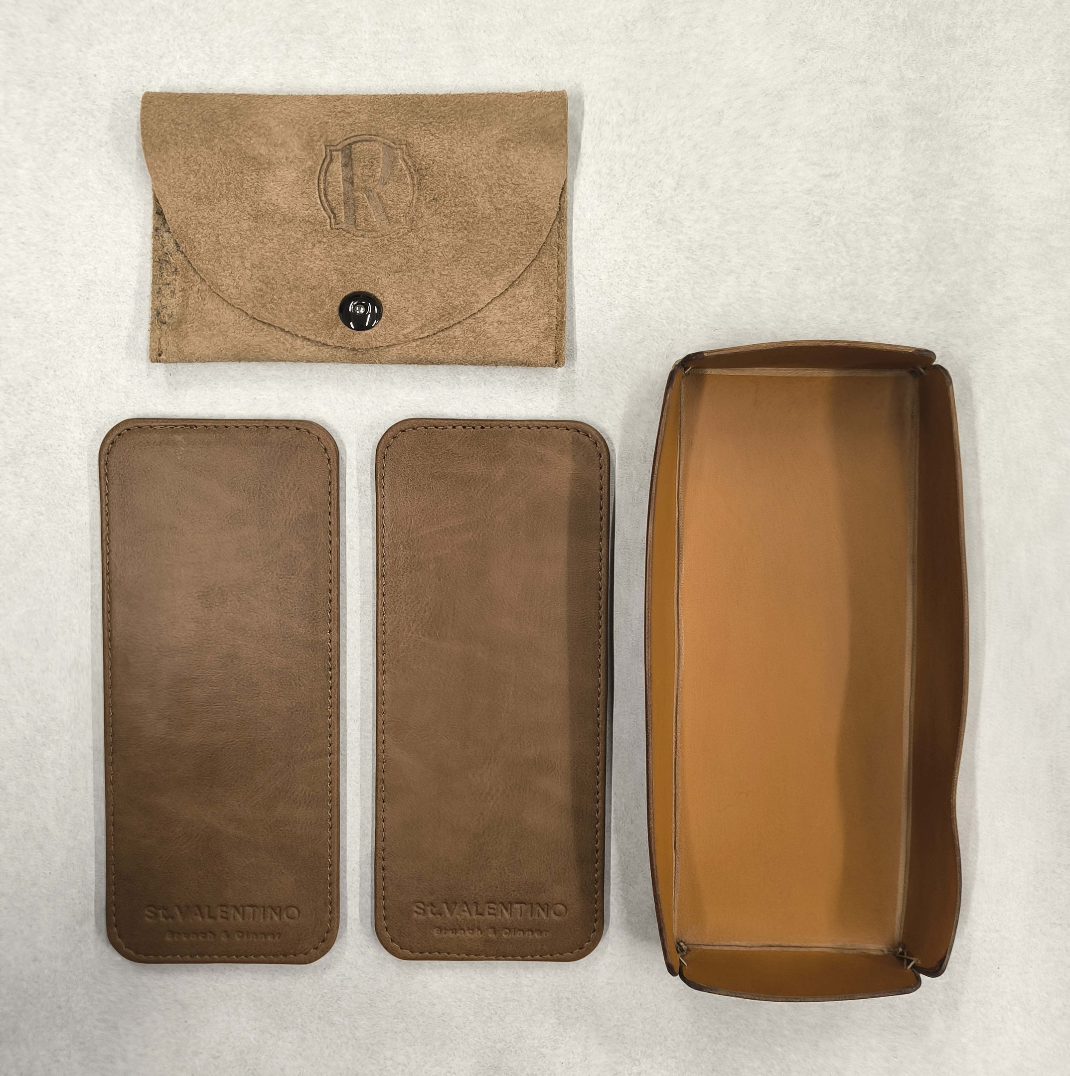 Custom brown leather valet tray with matching pouches and embossed logo branding.