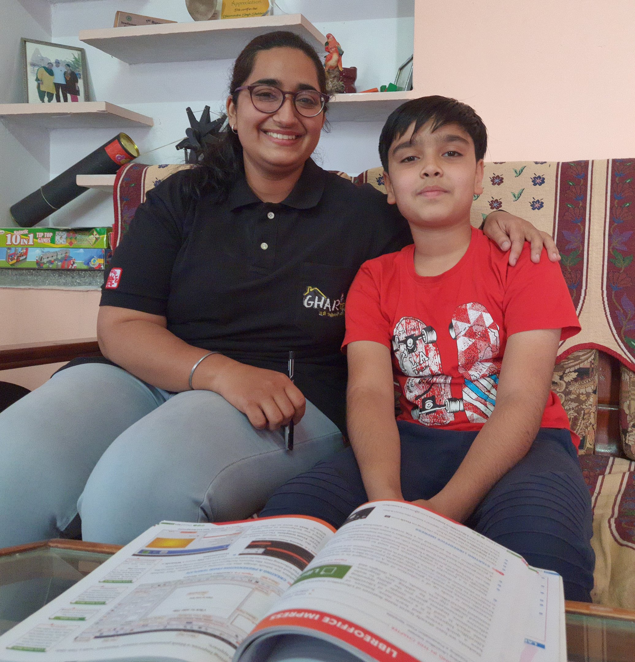 a tutor from gharpadh and a boy sitting on a couch