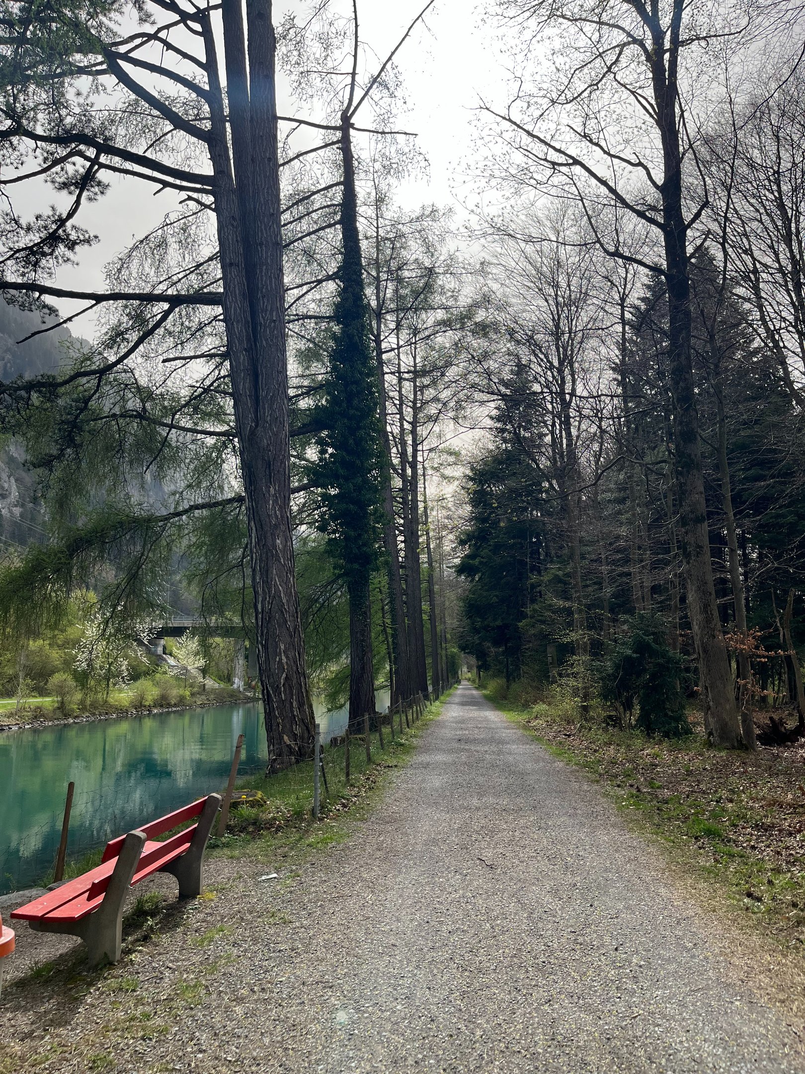A path along the blue water of the Interlaken Ship Canal in Interlaken Switzerland