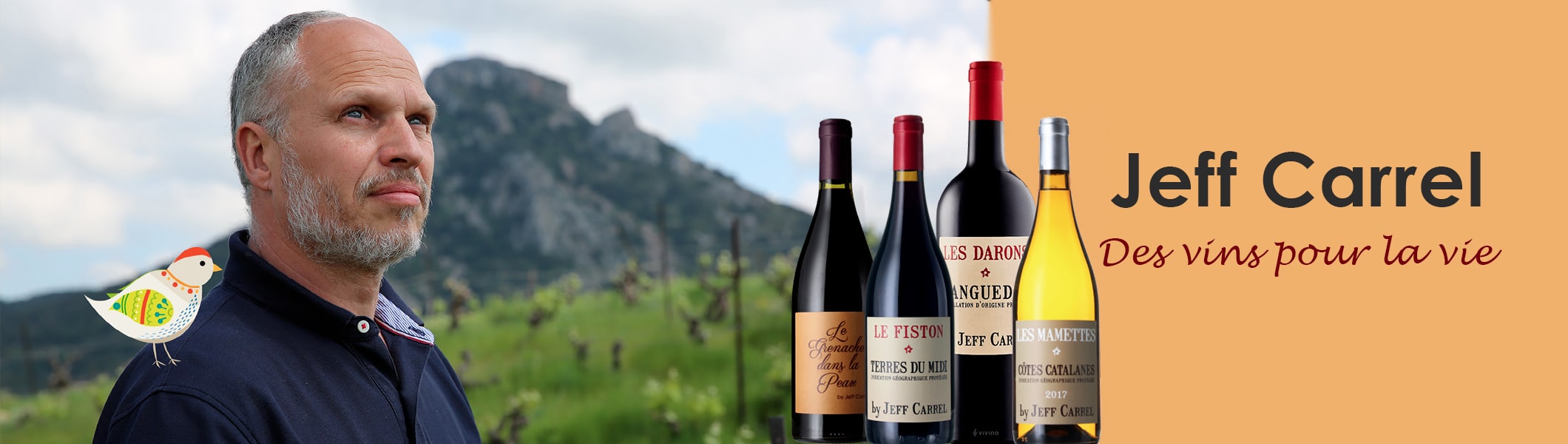 Winemaker Jeff Carrel next to a selection of his French red and white wine bottles.