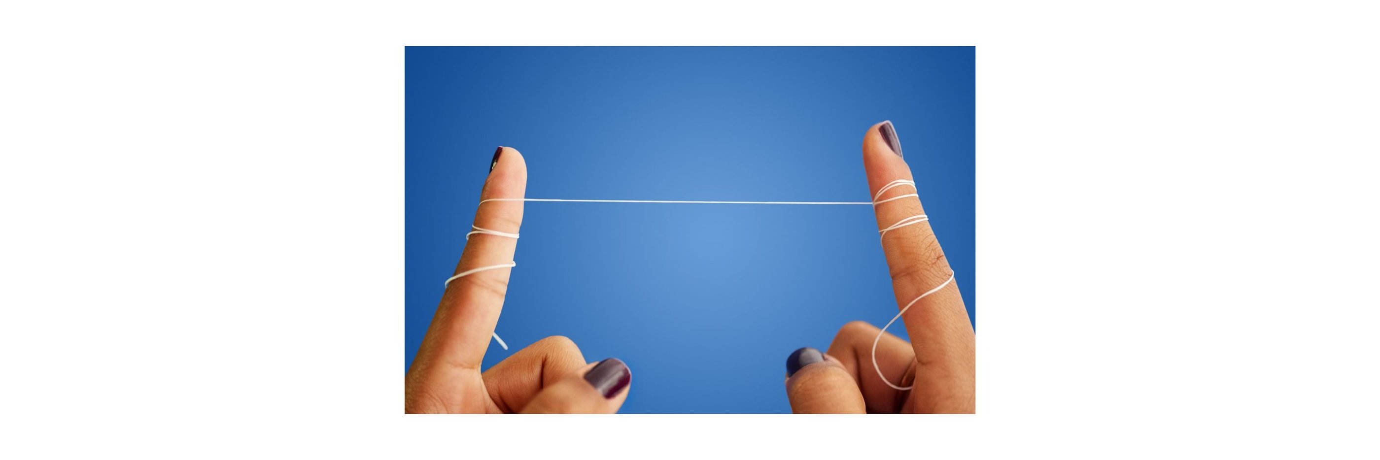 a person's fingers wrapped with a string of dental floss