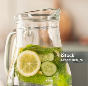 a pitcher of water with slices of cucumber in a pitcher