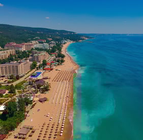 a beach with a view of a beach and a blue sky
