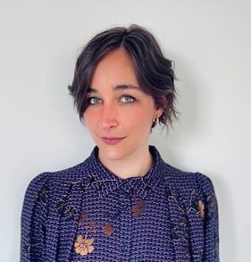 a woman with a purple and gold shirt
