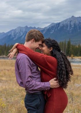 a man and woman standing in a field in Banff