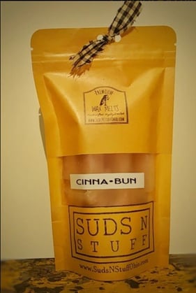 a rustic bag of wax melts. The label says 'cinnamon bun wax melts'.